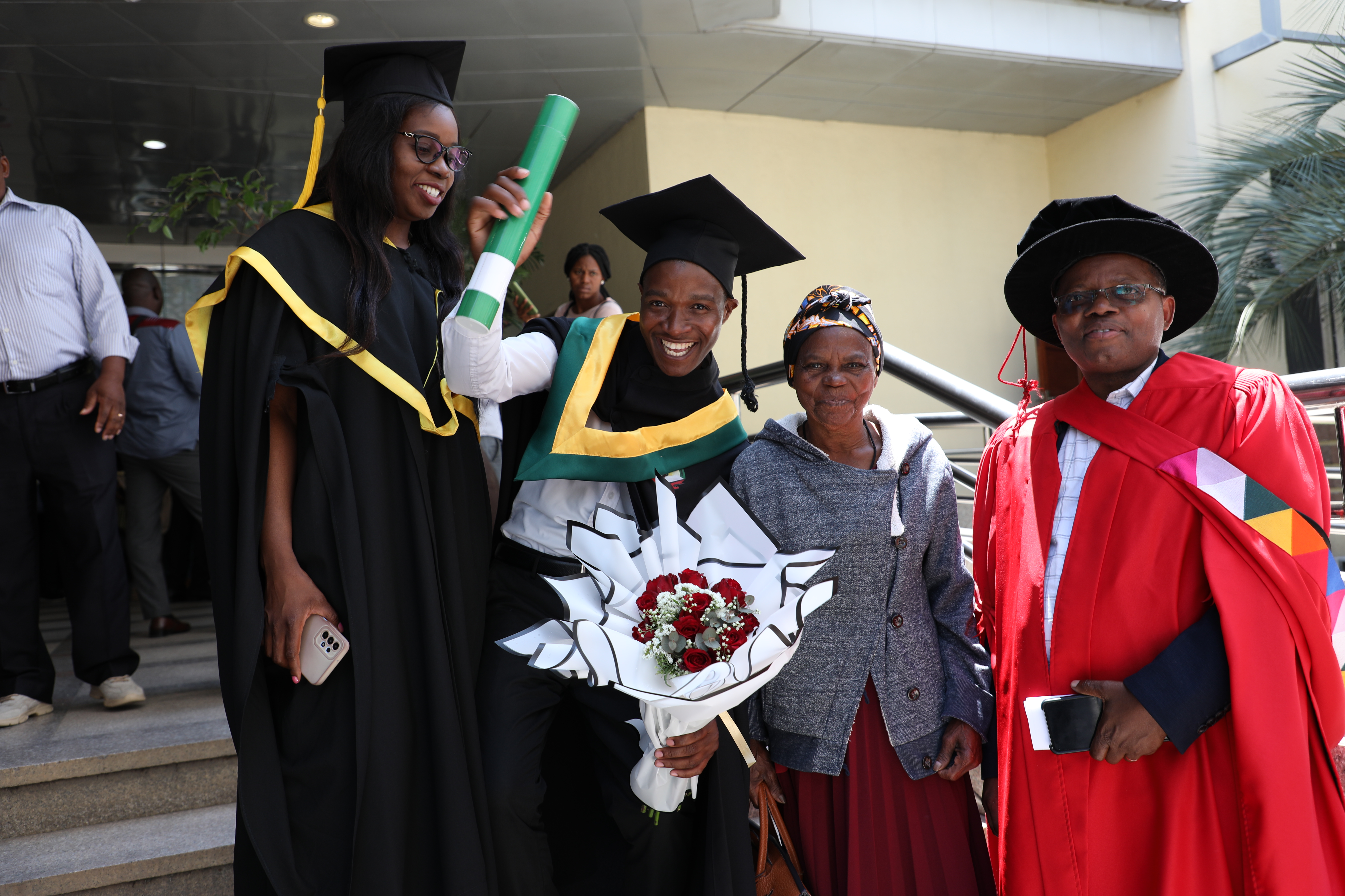 Beno Xavier, the third from right to left his diploma.