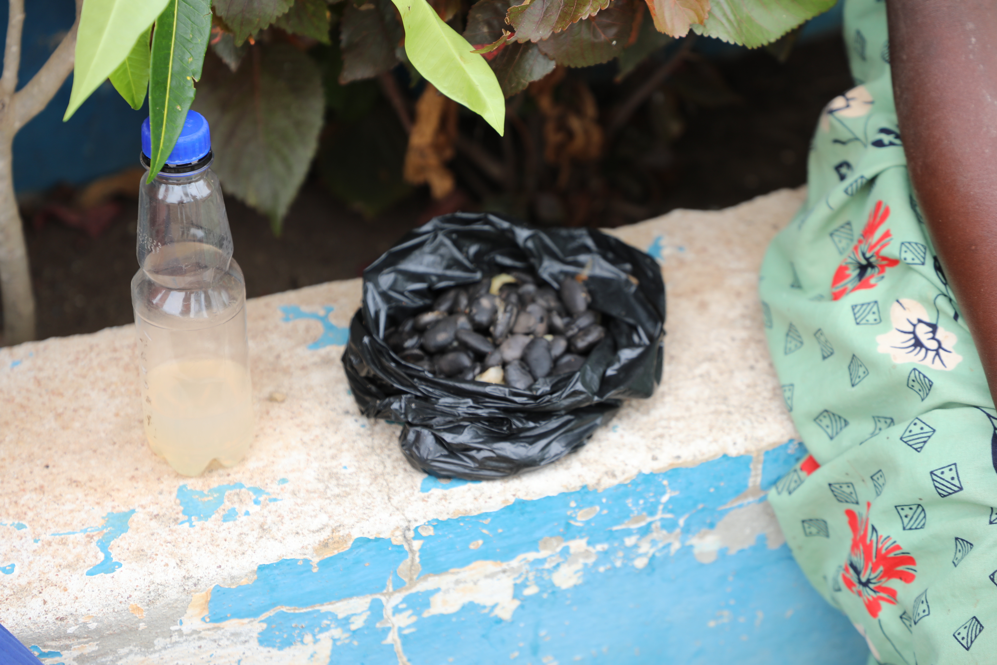 The black plastic with cooked beans helping Faida stand strong at this challenging time.