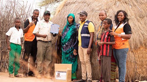 Obadiah Kisang, Director of World Vision's IMARA programme (third from Left) with World Vision staff at one of the homes where children benefited from solar technology products. ©World Vision Photo/Wesley Koskei.