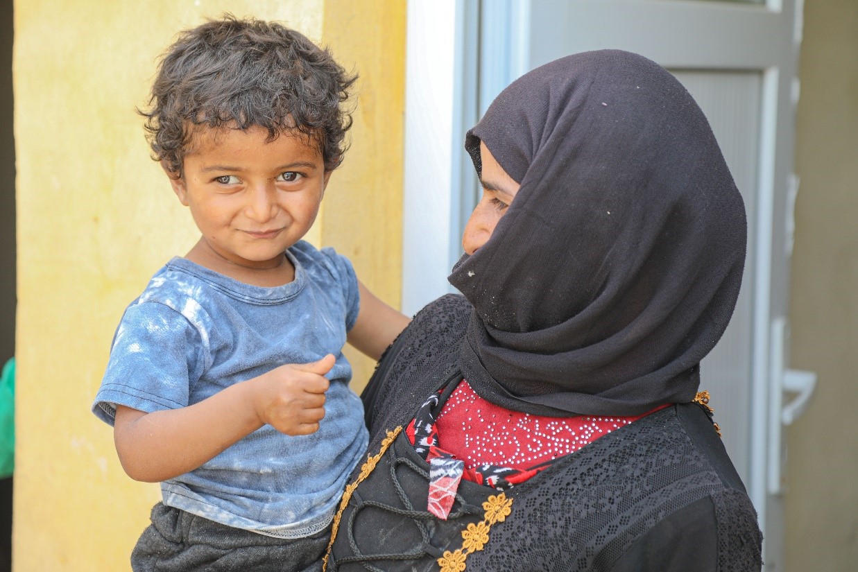 Tamer being held by his mother. Physicians Across Continents, World Vision Syria Response Partner