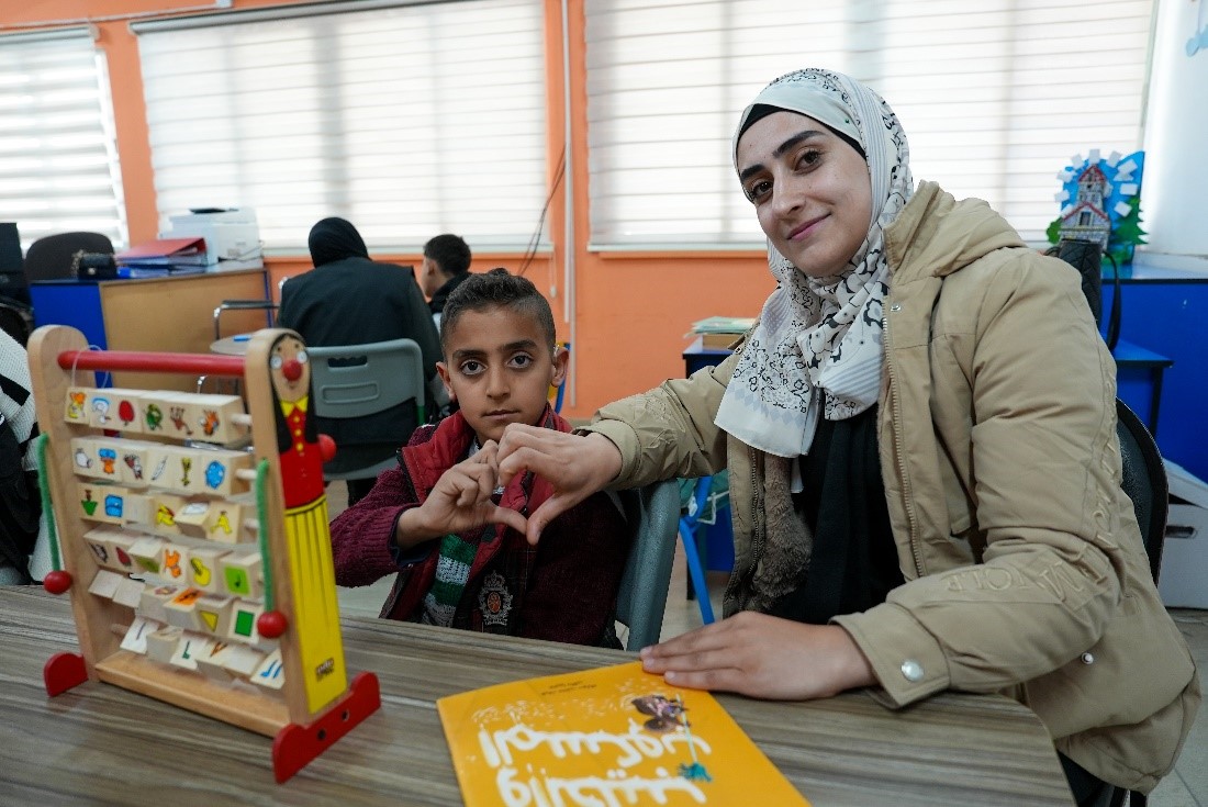 Asmaa and Nabil in the resource room established by World Vision