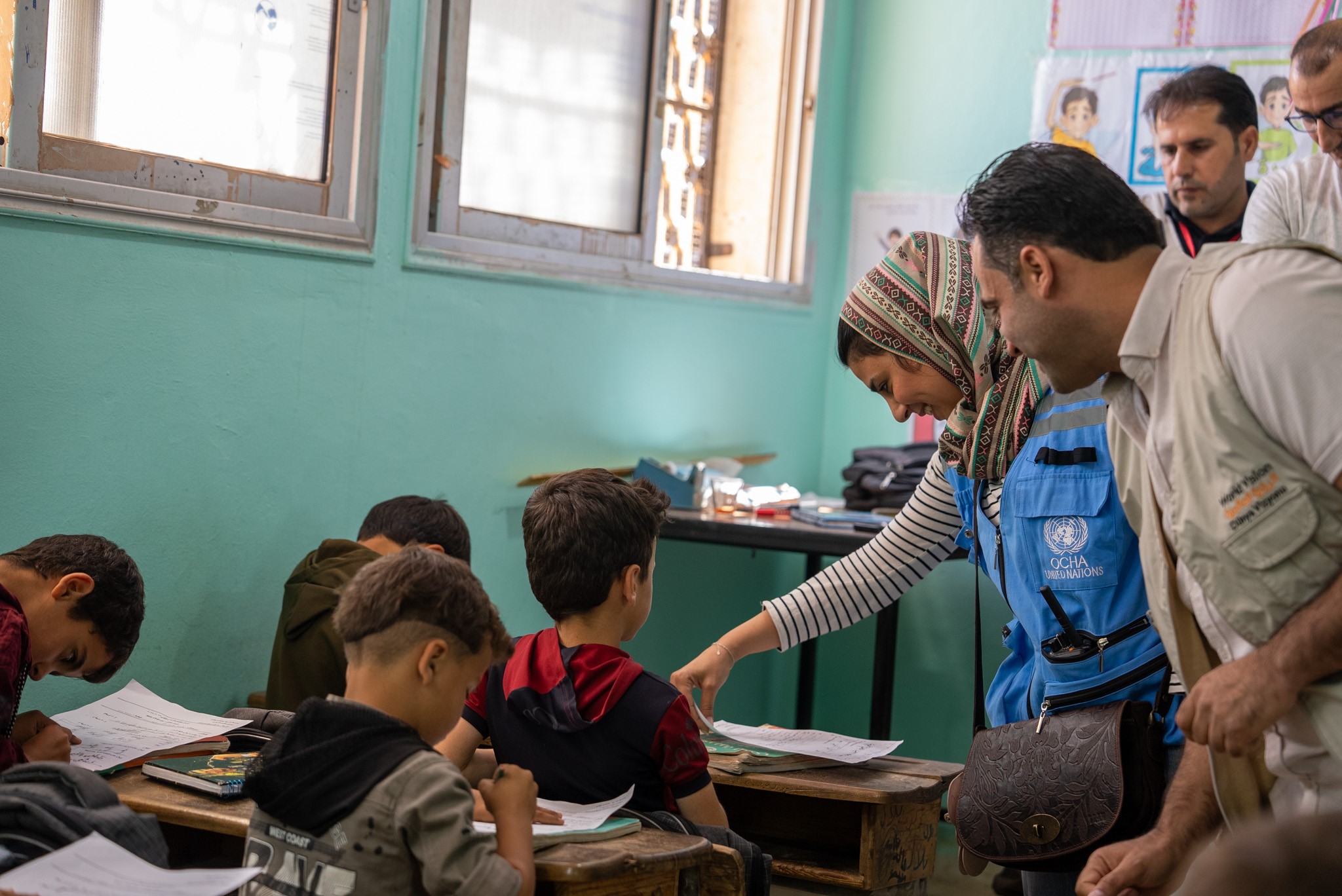 World Vision Syria Response and Syria Cross-border Humanitarian Fund (SCHF) staff members in Yassin’s classroom.
