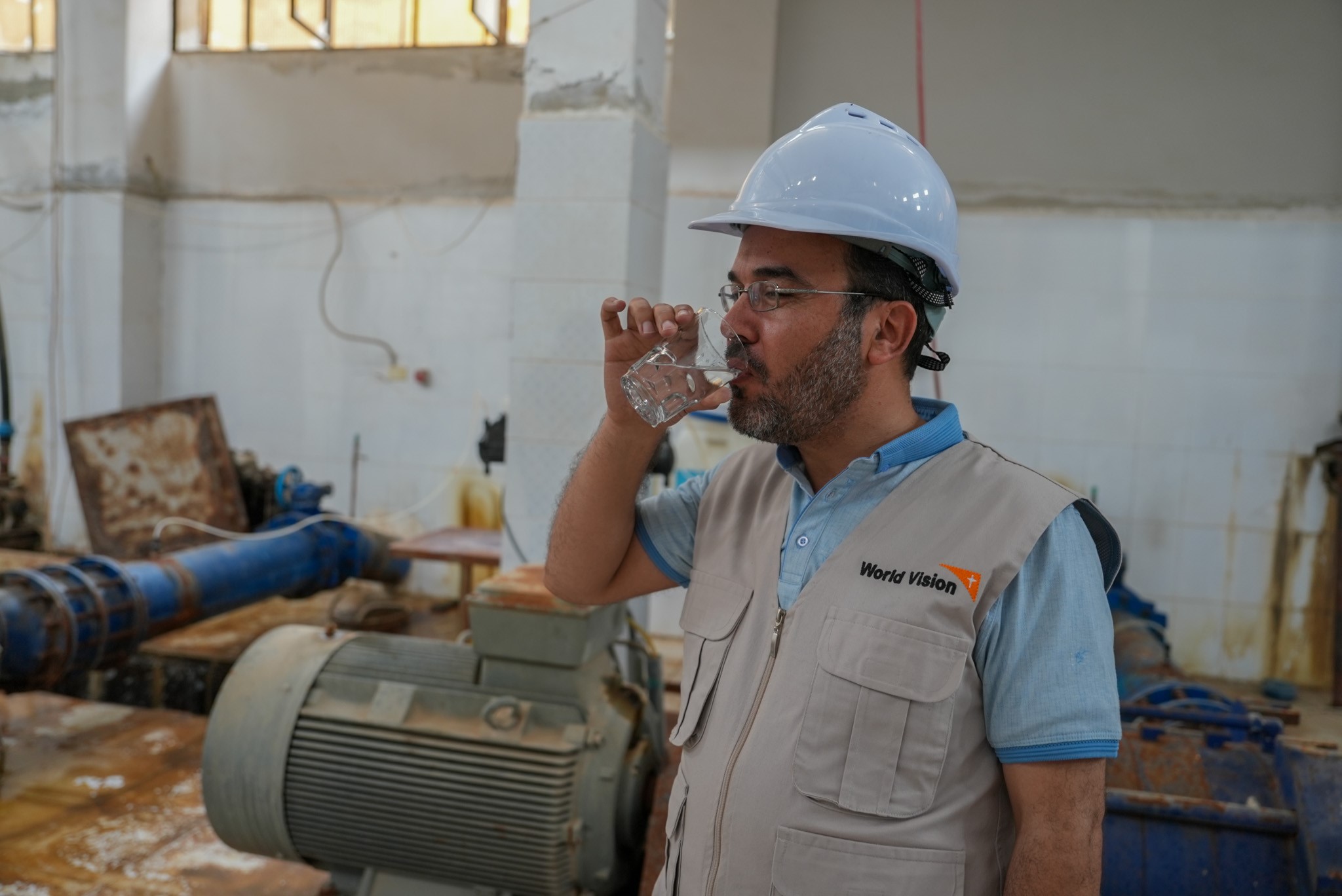 Syria Response staff drinking water provided from the water station. World Vision Syria Response, Zaher Jaber