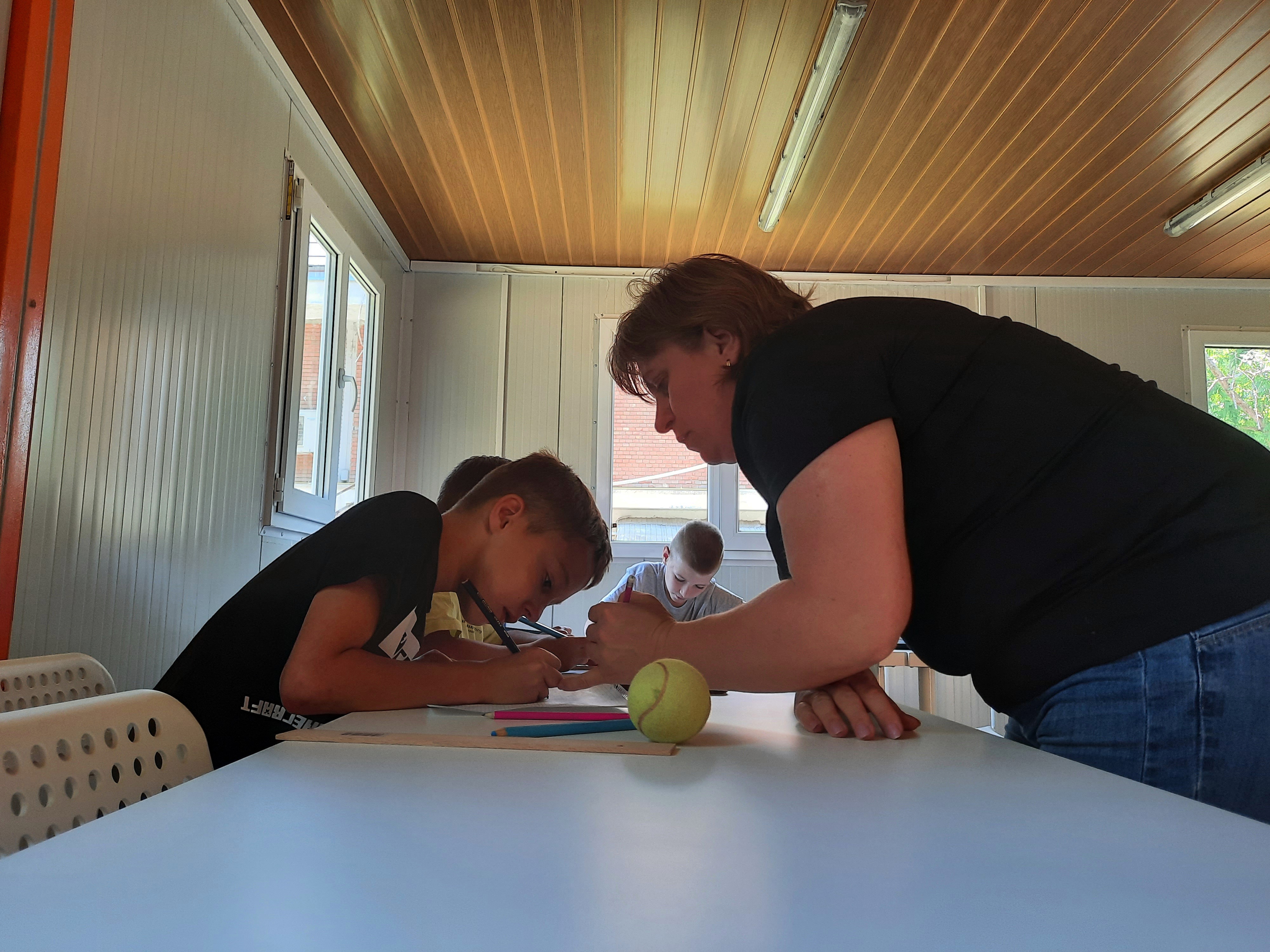 Svetlana teaches maths to Ukrainian children at the Happy Bubble in Romania