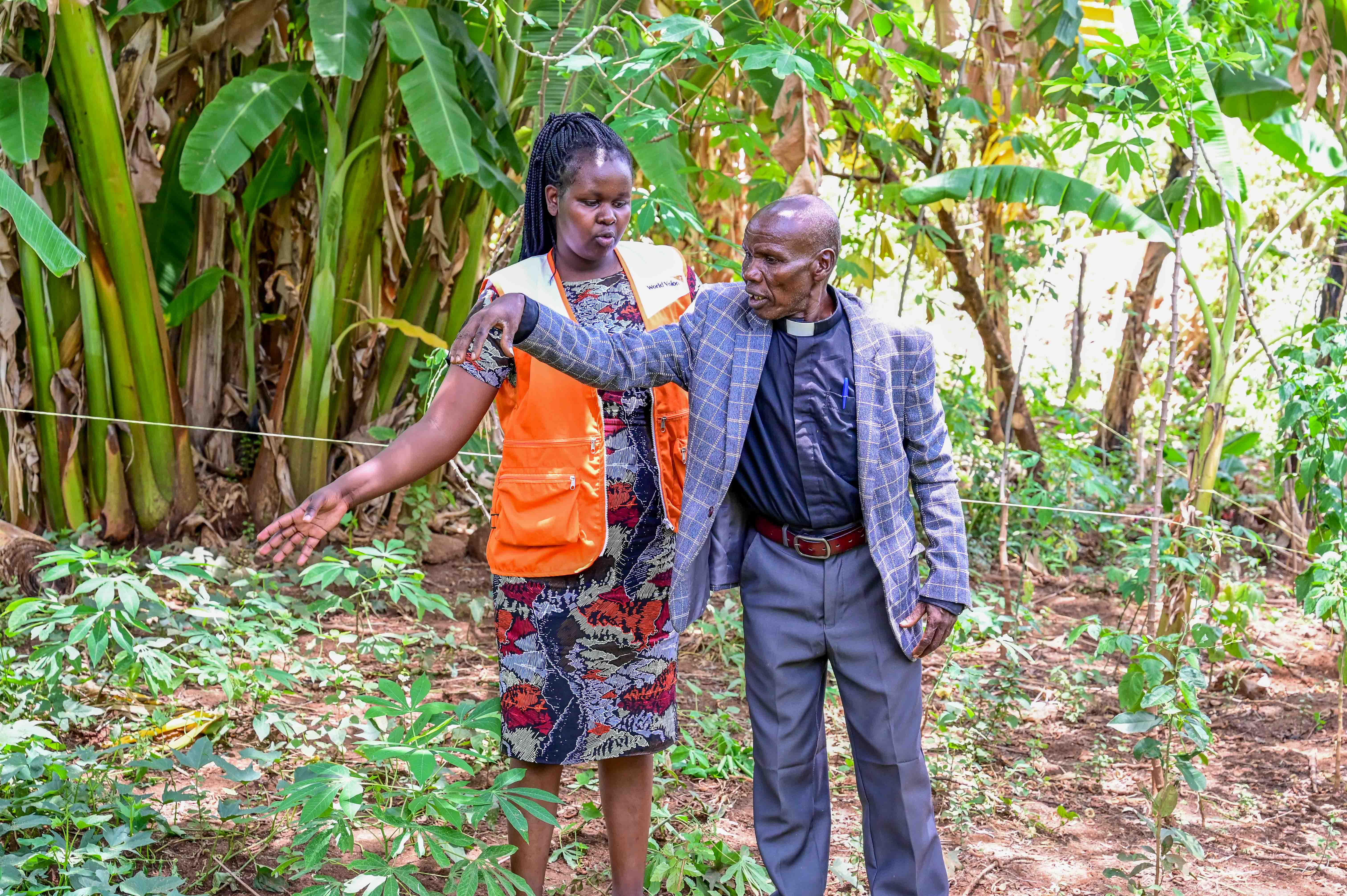 Maximilla Kanda, CRIFSUP Project Officer at World Vision, visits Pastor Wilson on his now-reclaimed farm. Thanks to restoration efforts, the land, once marred by deep gullies, has been restored through sustainable land management. ©World Vision Photo/Hellen Owuor