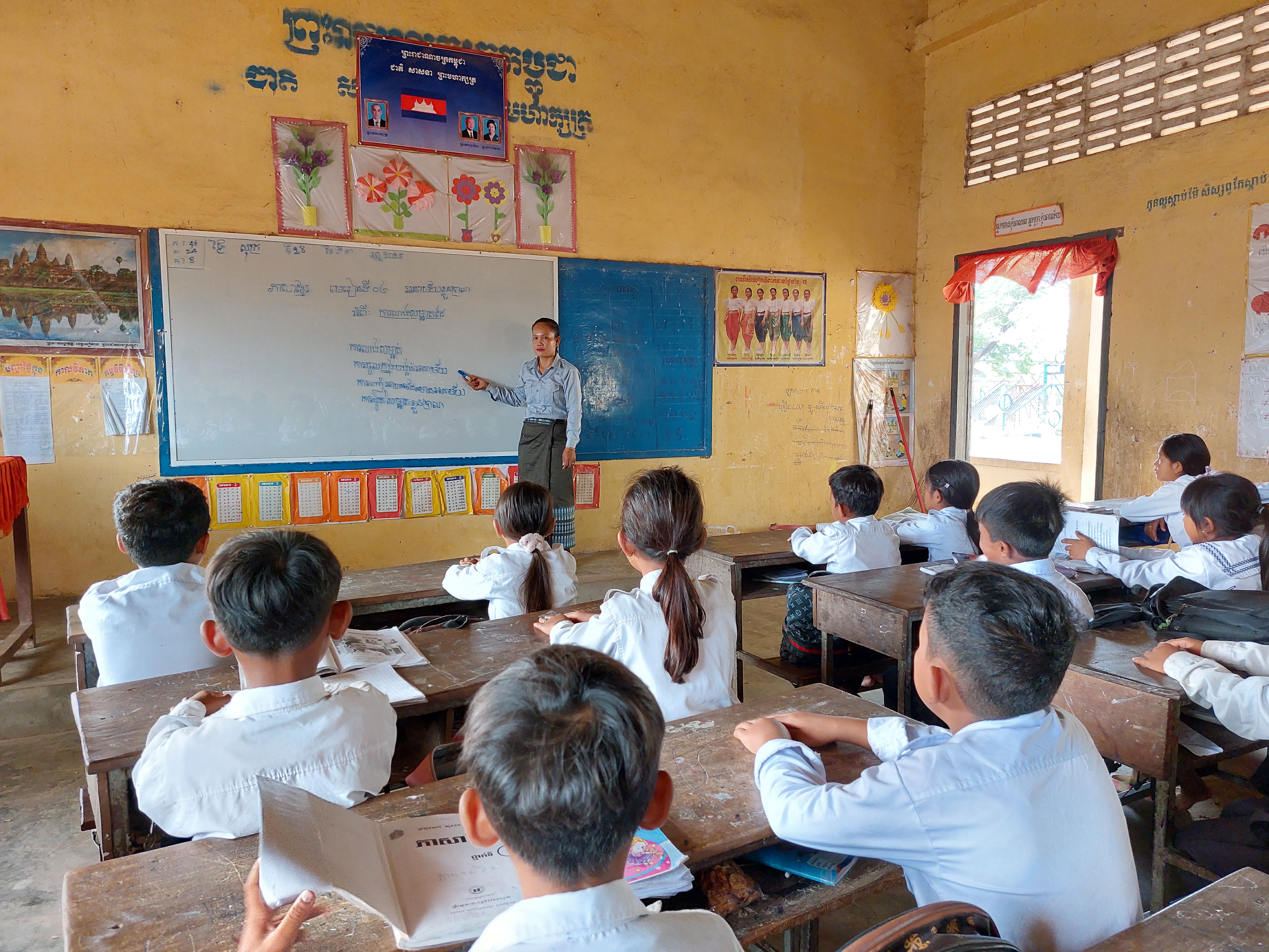 Ms. Sieng Ky, a grade 4 teacher at a primary school in Banteay Meanchey, is teaching her students.