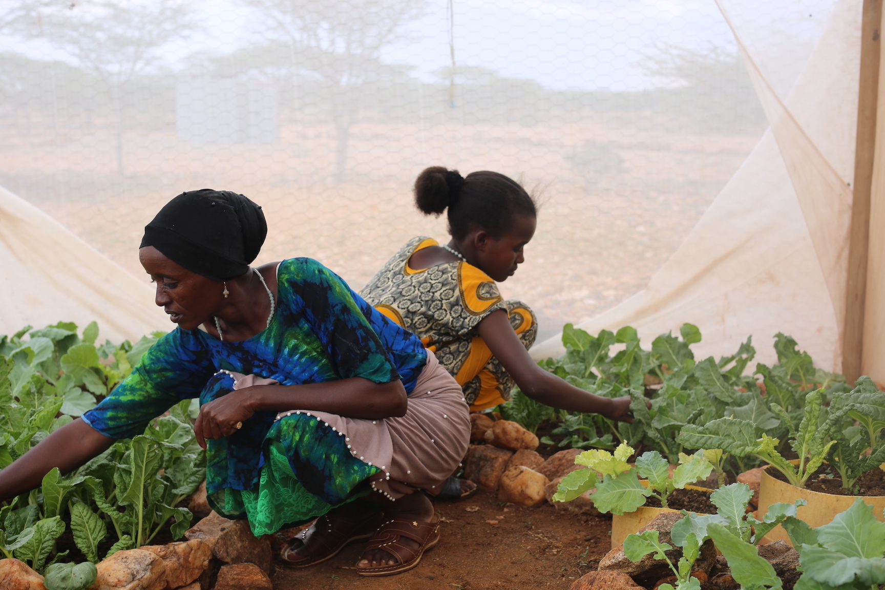 Saroi with her daughter Neitumu (10) at her kitchen garden in Kenya's Laisamis County. ©Copyright World Vision/By Irene Sinoya.