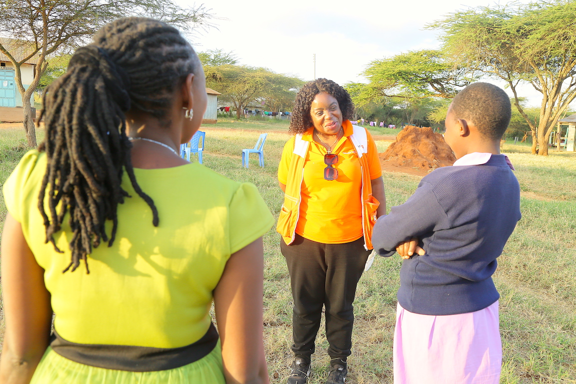 Lilian Dodzo, the National Director for World Vision Kenya listens to Stella talking about the positive impact that the school has had in her life. 