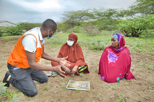 Mramba (WV project manager) explains a concept to beneficiaries.