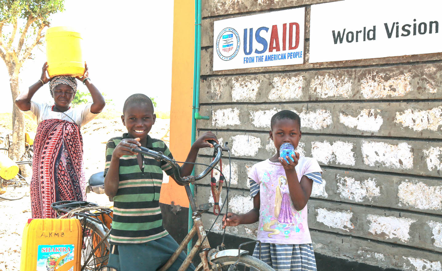 A family collects water at the Mapotea Water Point