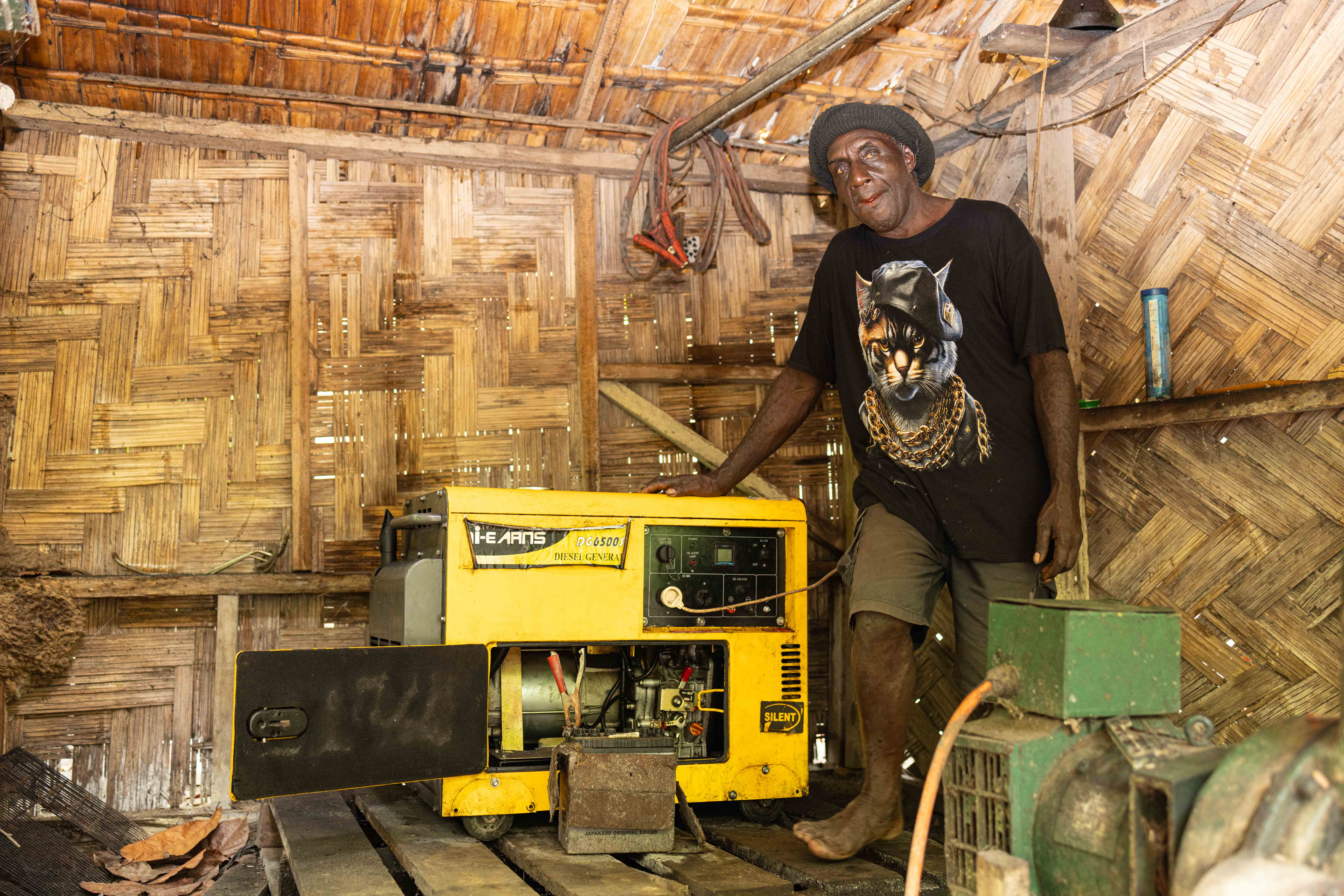 Sam standing proudly to the first genset he purchased from the first loan