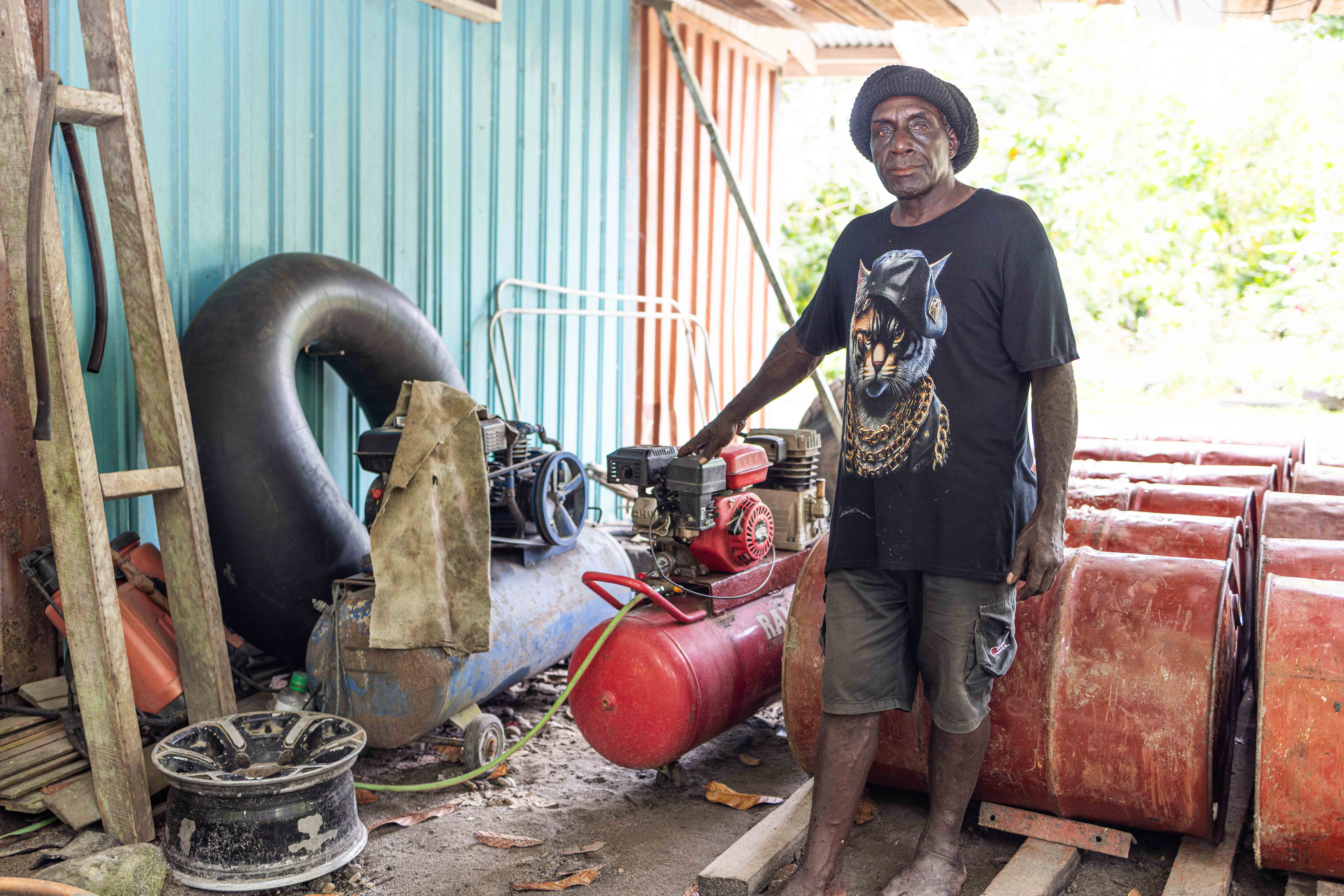 Sam standing proudly next to the Compressure he purchased from the second loan