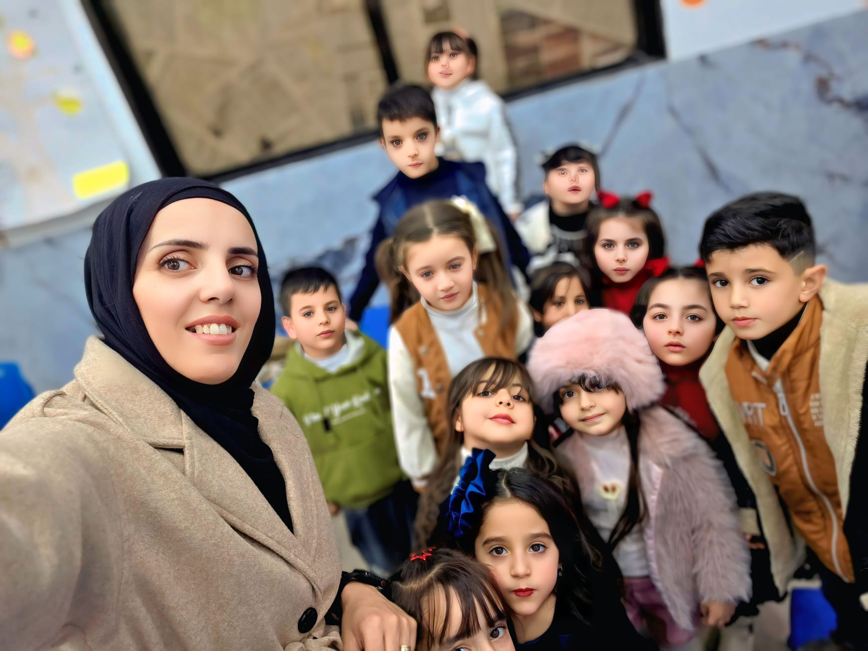 Jumana with children at Kids Club Kindergarten in Beit Awwa, where she works to create a safe and supportive environment that helps children feel valued, protected, and encouraged to learn and grow.