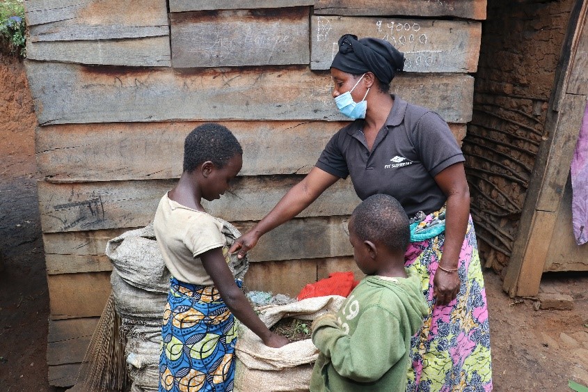 Rebecca and her children checking the droppings