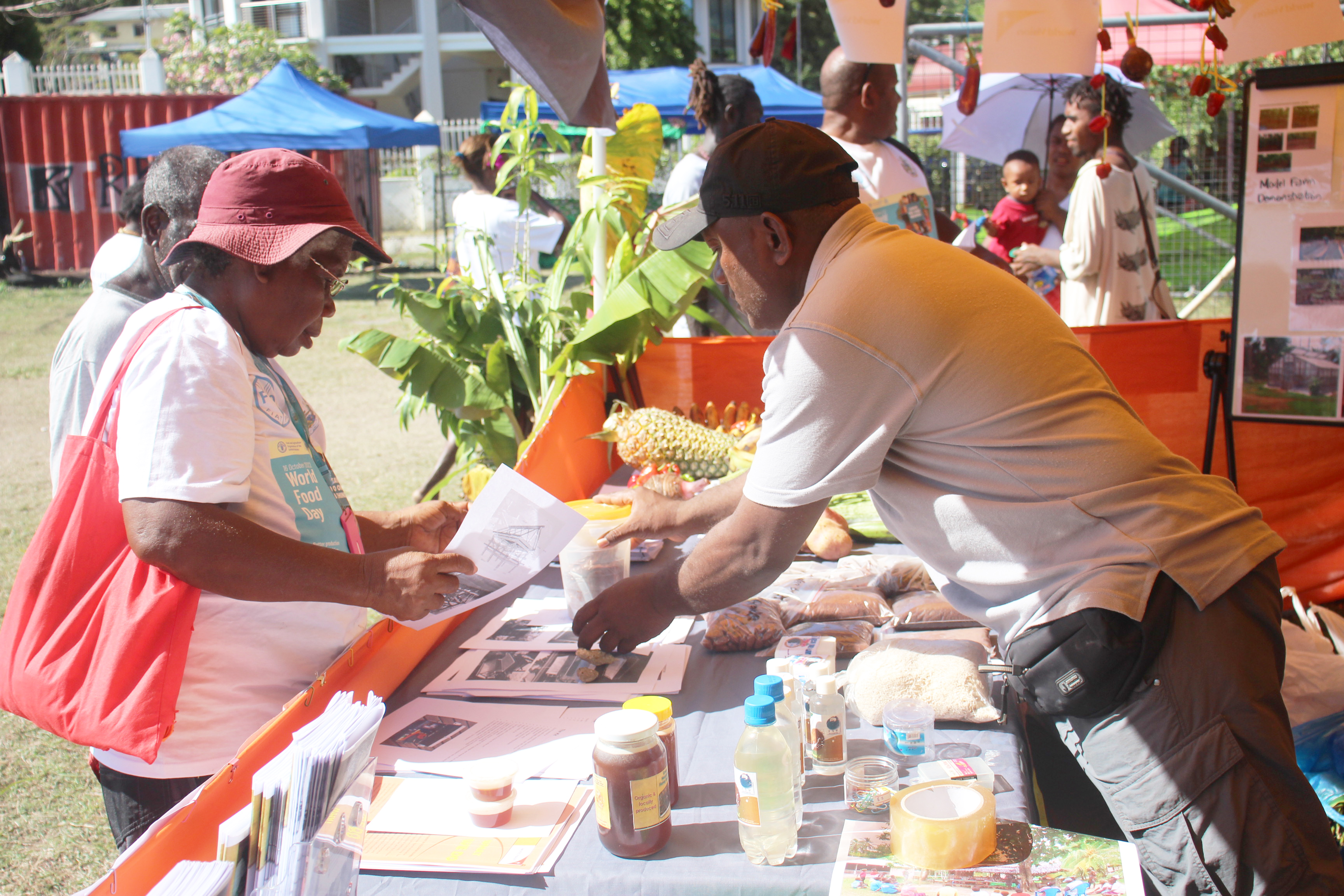 Osbert Lalahu explaining WVSI work to visitors to the stall