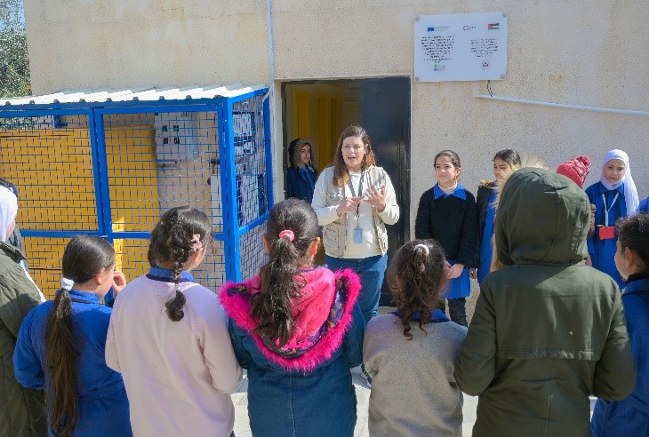              A World Vision staff member is introducing students from grades 4 & 5 to the project and the planting campaign.