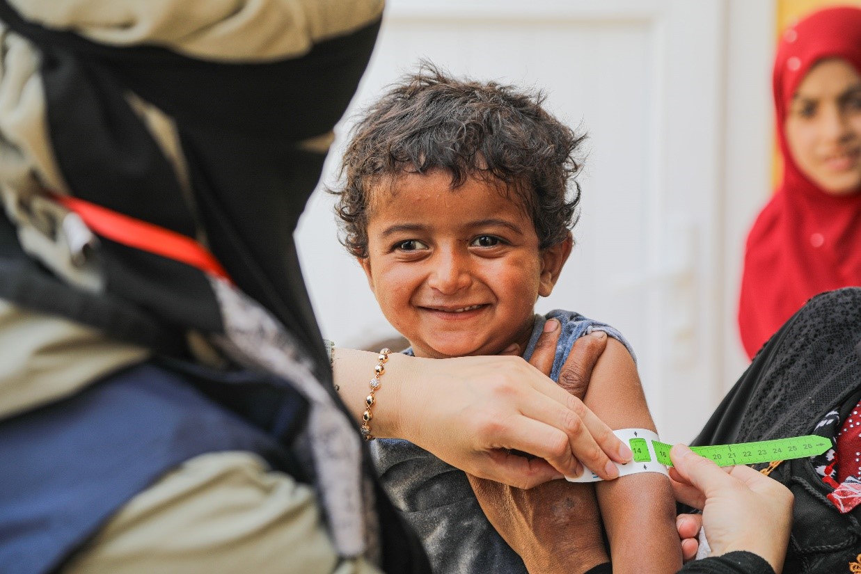 Tamer during the final MUAC measurement when he recovered from malnutrition. Physicians Across Continents, World Vision Syria Response Partner