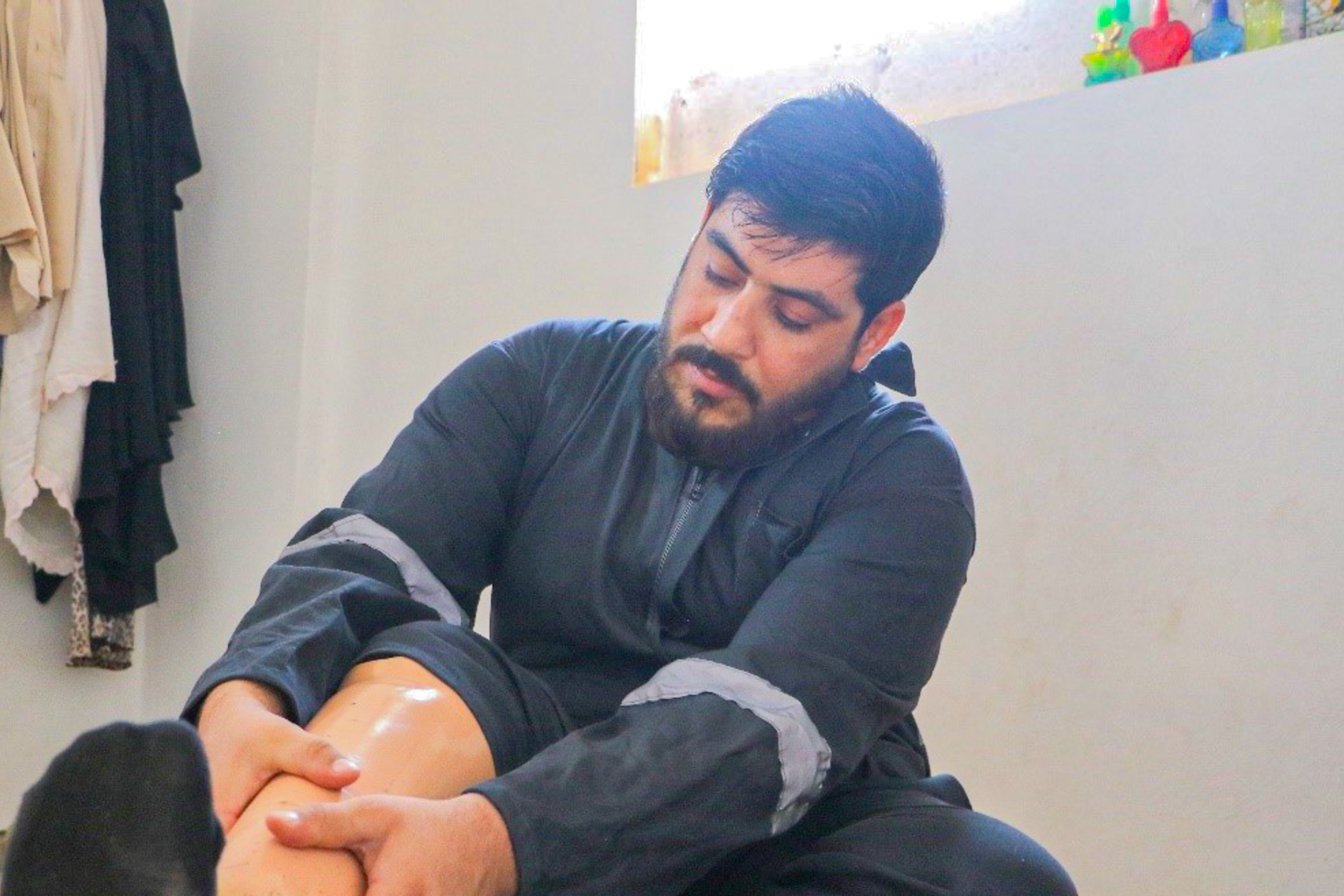 Yaser putting on his artificial leg World Vision Syria Response Partner, Orange