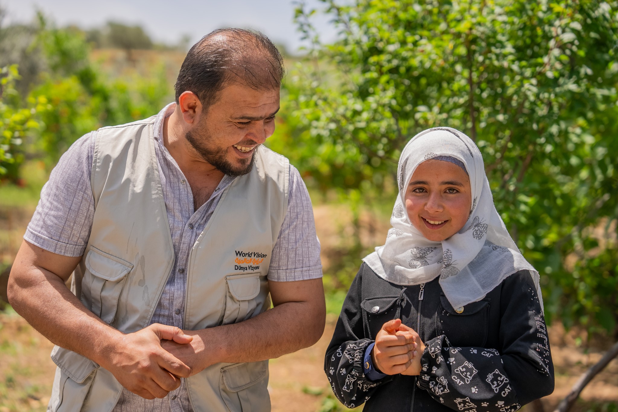 Qamar with a World Vision Syria Response staff.