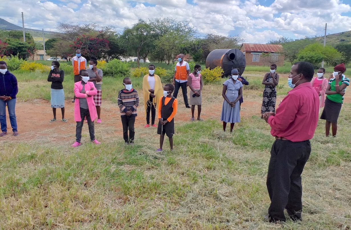 3-Children at Ilbisil Primary School and Rescue Centre, together with their caregivers. They are being sensitised on COVID-19 prevention by a health expert during a forum organised by World Vision at Osiligi in Kajiado, Kenya.