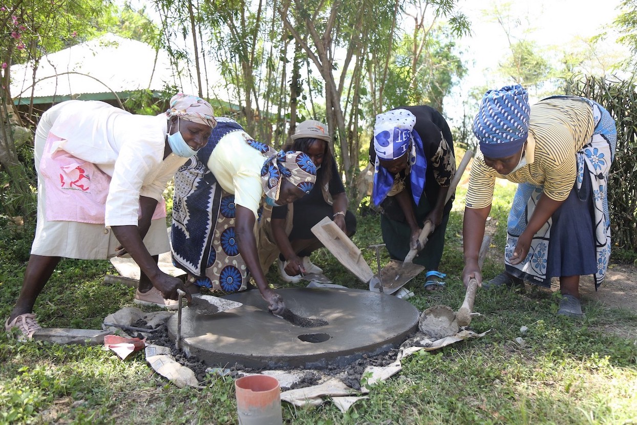 Tha Kosano CLTS group making the SanPlat concrete slab. World Vision trained them on the technology.