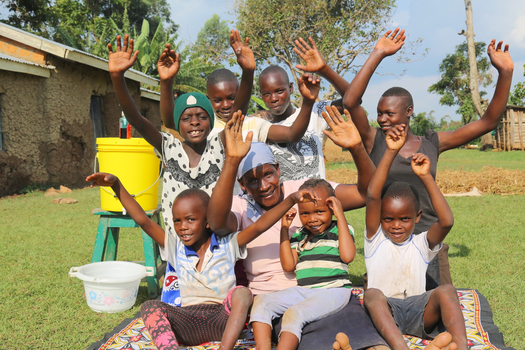 Raphael with his grandmother and siblings displaying their clean hands after learning how to wash them well with soap and water. ©World Vision Photo/Irene Sinoya.