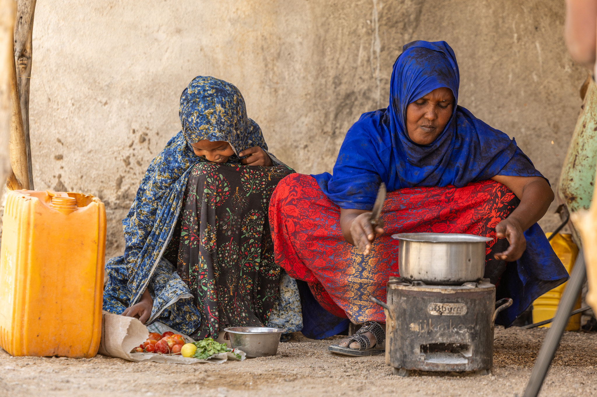 Fadumo and her daughter prepare a family lunch using fresh vegetables grown on their farm, highlighting the farm-to-table connection.