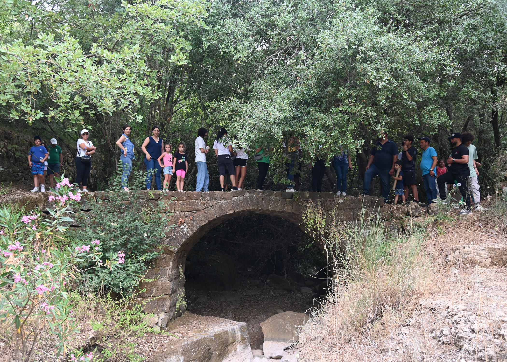 Community standing over a bridge while hiking in Arsoun