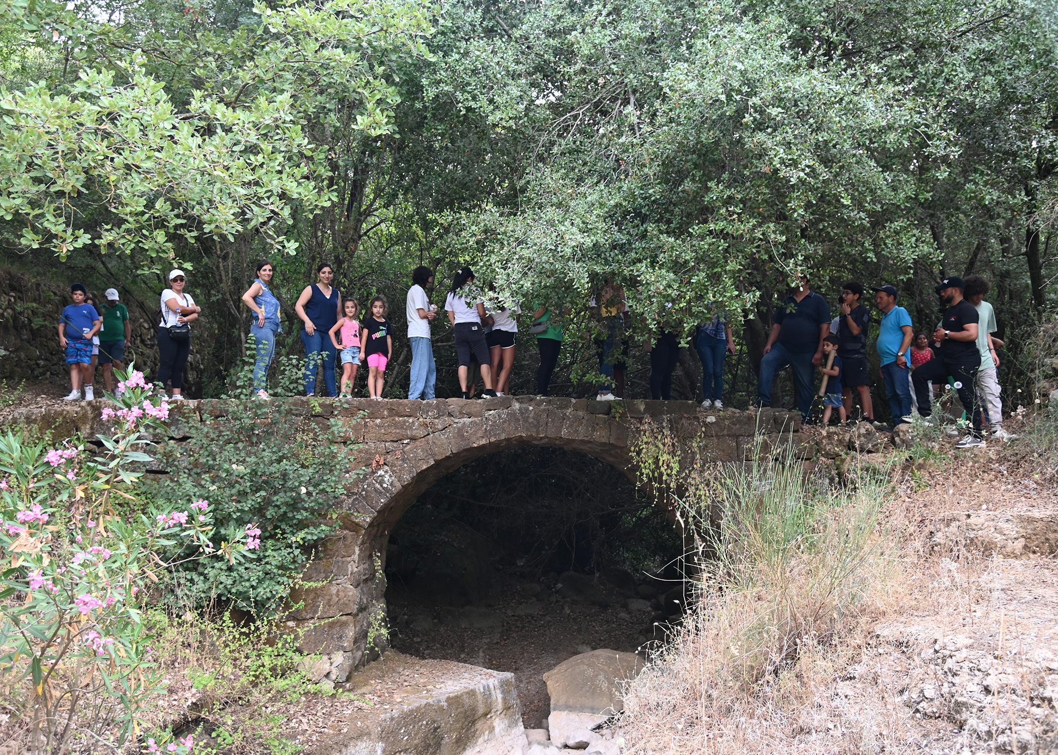 Community standing over a bridge while hiking in Arsoun 