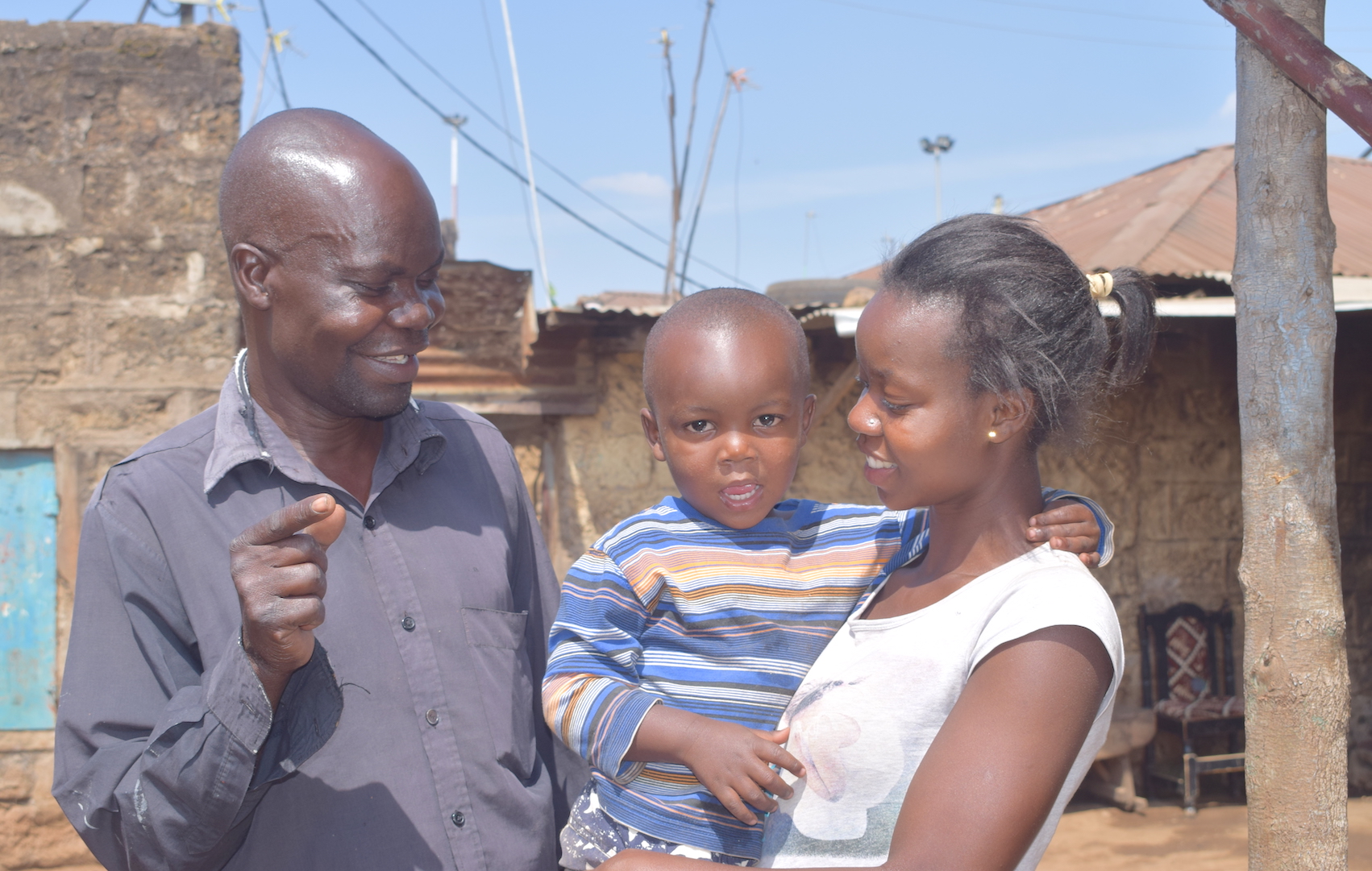 Julius (left), his two-year-old grandson Ivan and daughter Mercy.