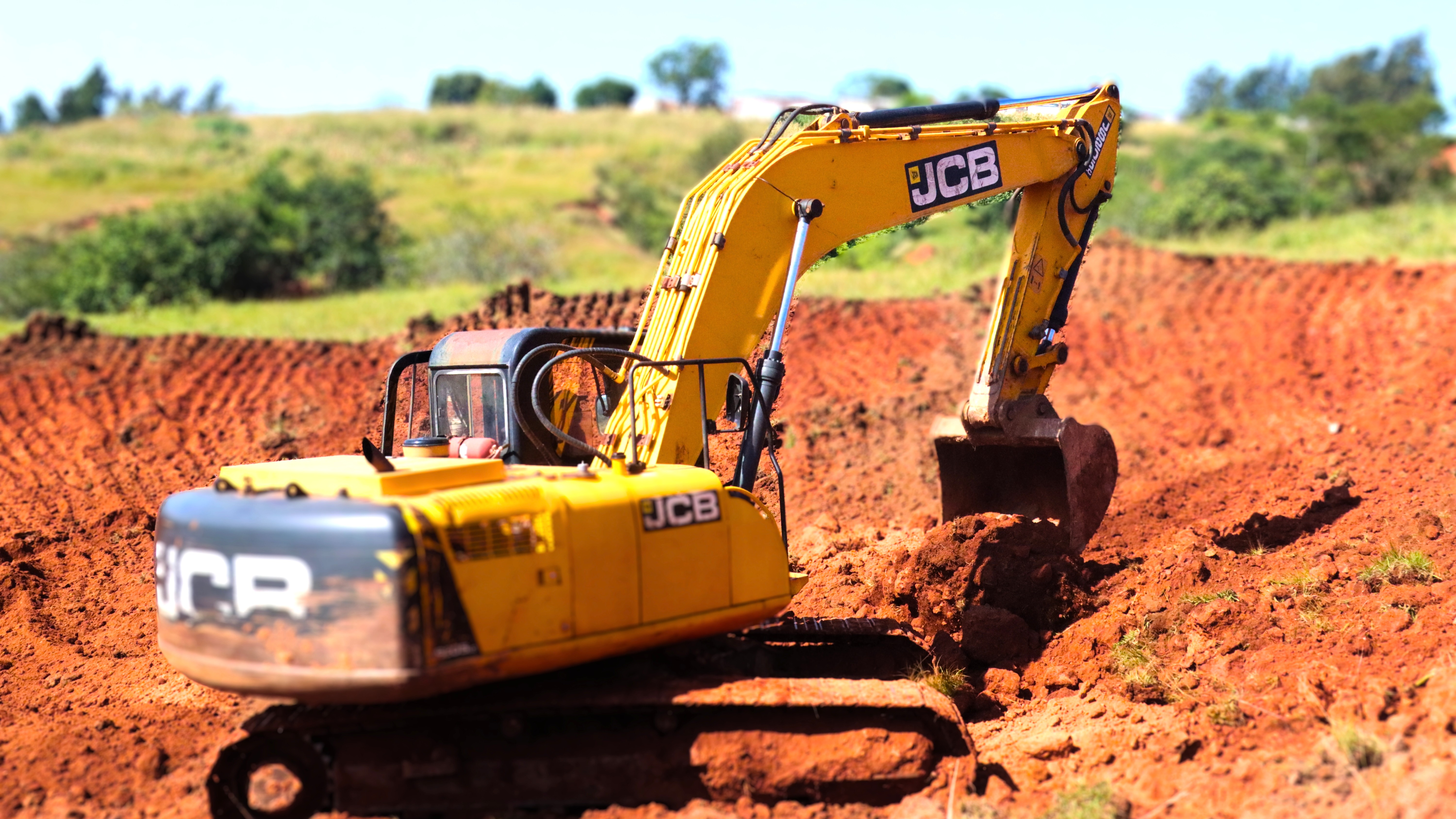 An excavator fixing a donga as part of a natural regeneration project by World Vision.