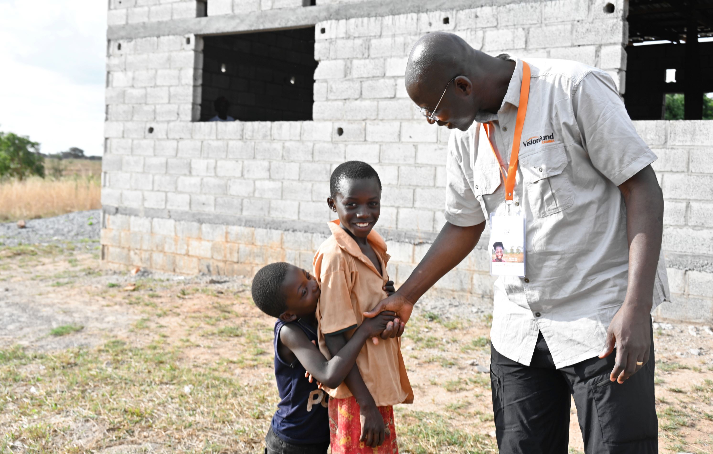 JBK warmly greets children from the Lukoshi Savings Group in Zambia, celebrating community and connection