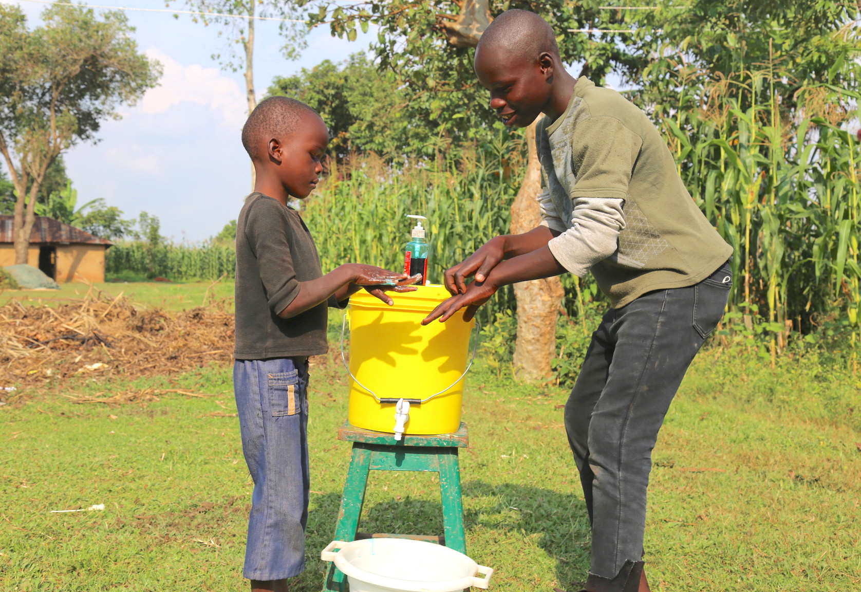 Raphael (right) teaches his brother how to effectively wash hands with soap to prevent COVID-19 and other disease. ©World Vision Photo/Irene Sinoya.