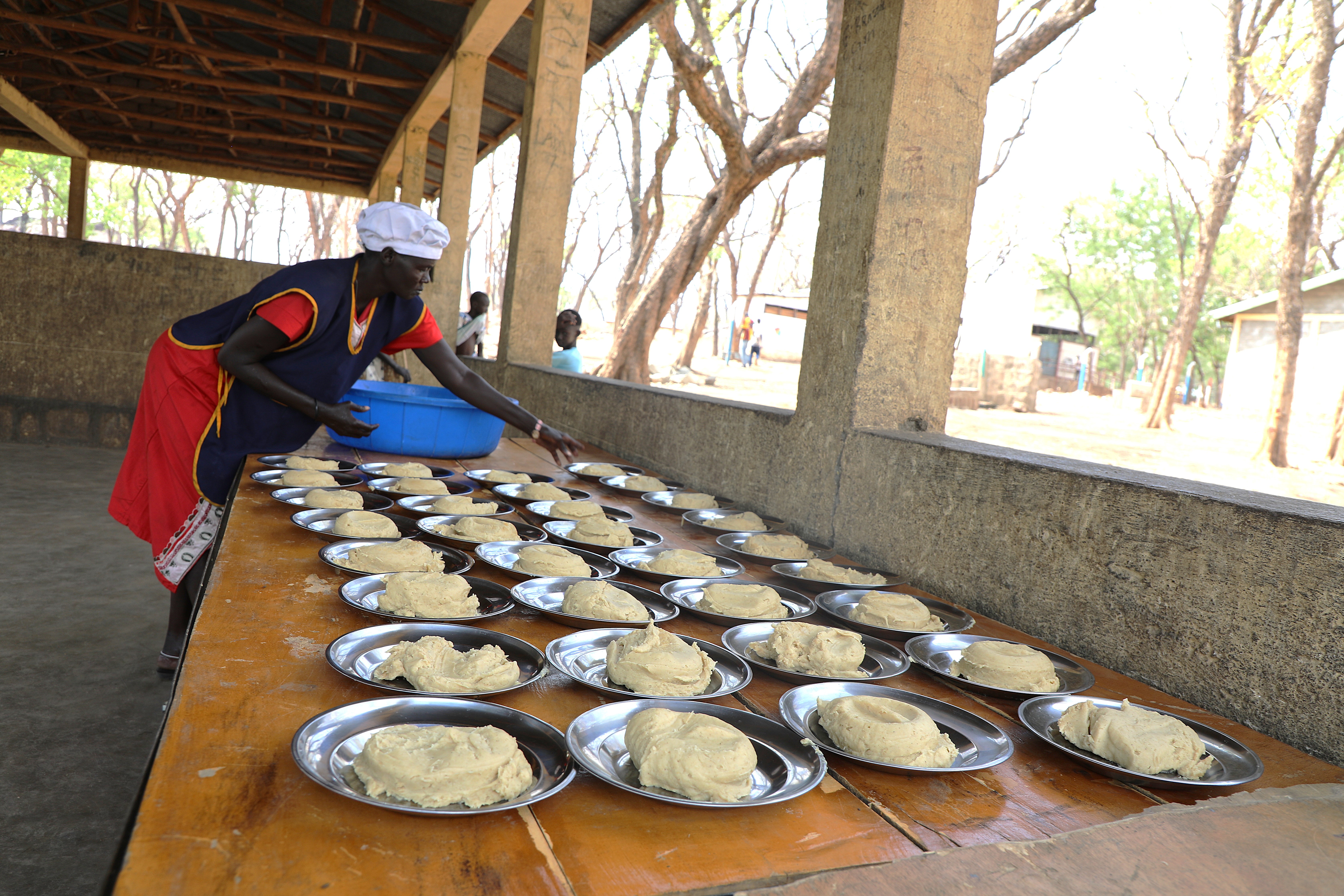A plate of porridge made from a daily ration of 120g Corn Soya Blend Plus (CSB+), 8g vegetable oil, and 3g salt, provided by the donor for school-going children as a nutritious meal.