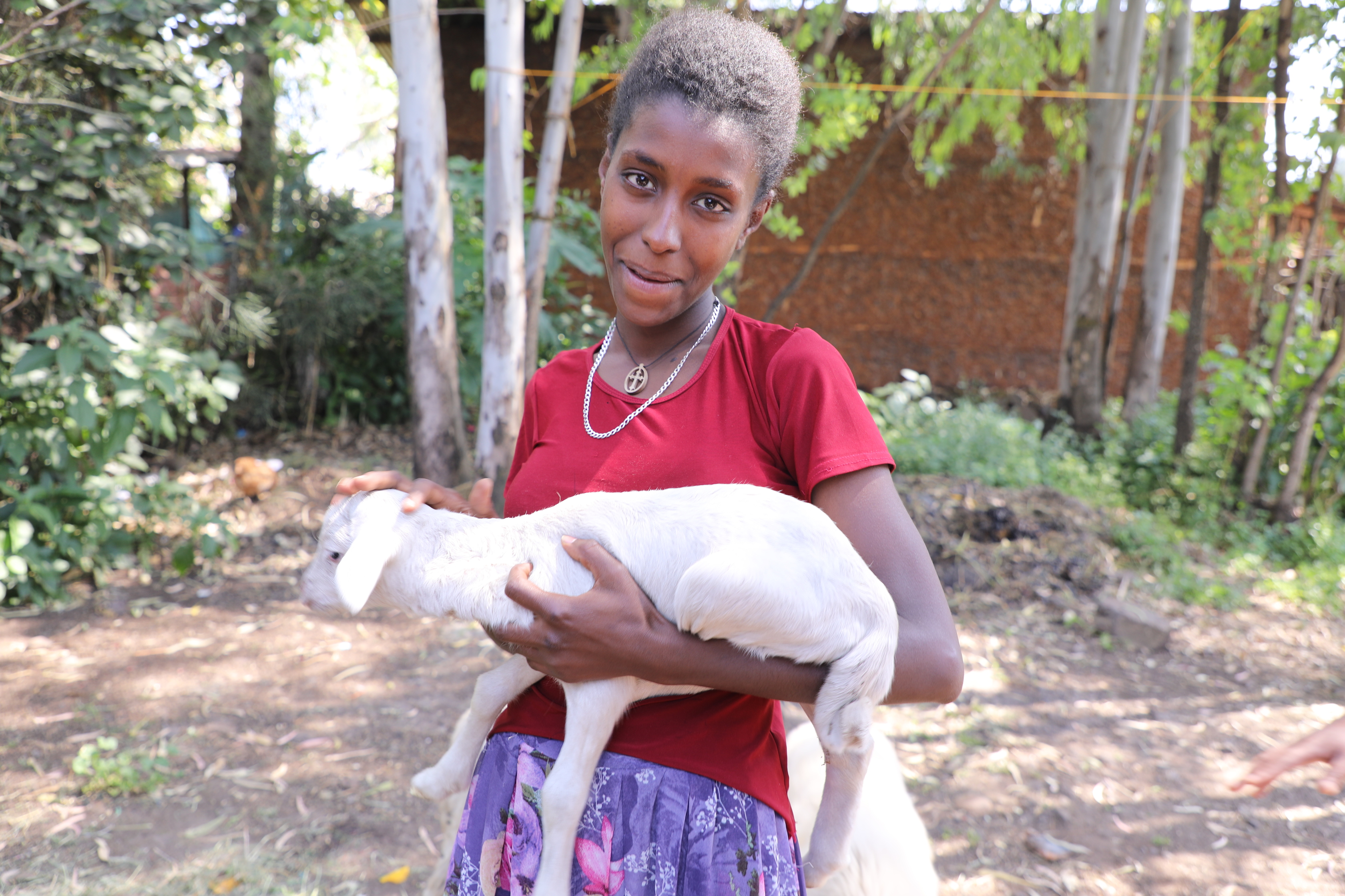 Mastewal happily holding her sheep 