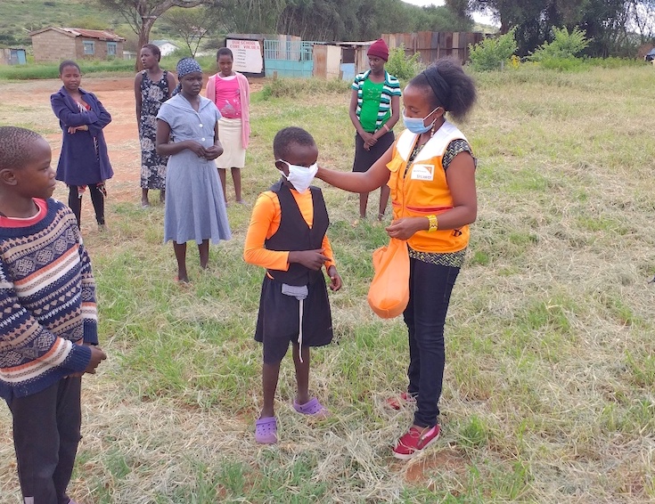 6-Elijah,10, learns how to wear a mask based on lessons being given by Tabitha Mwangi, the Manager for World Vision Osiligi Area Programme in Kajiado, Kenya.