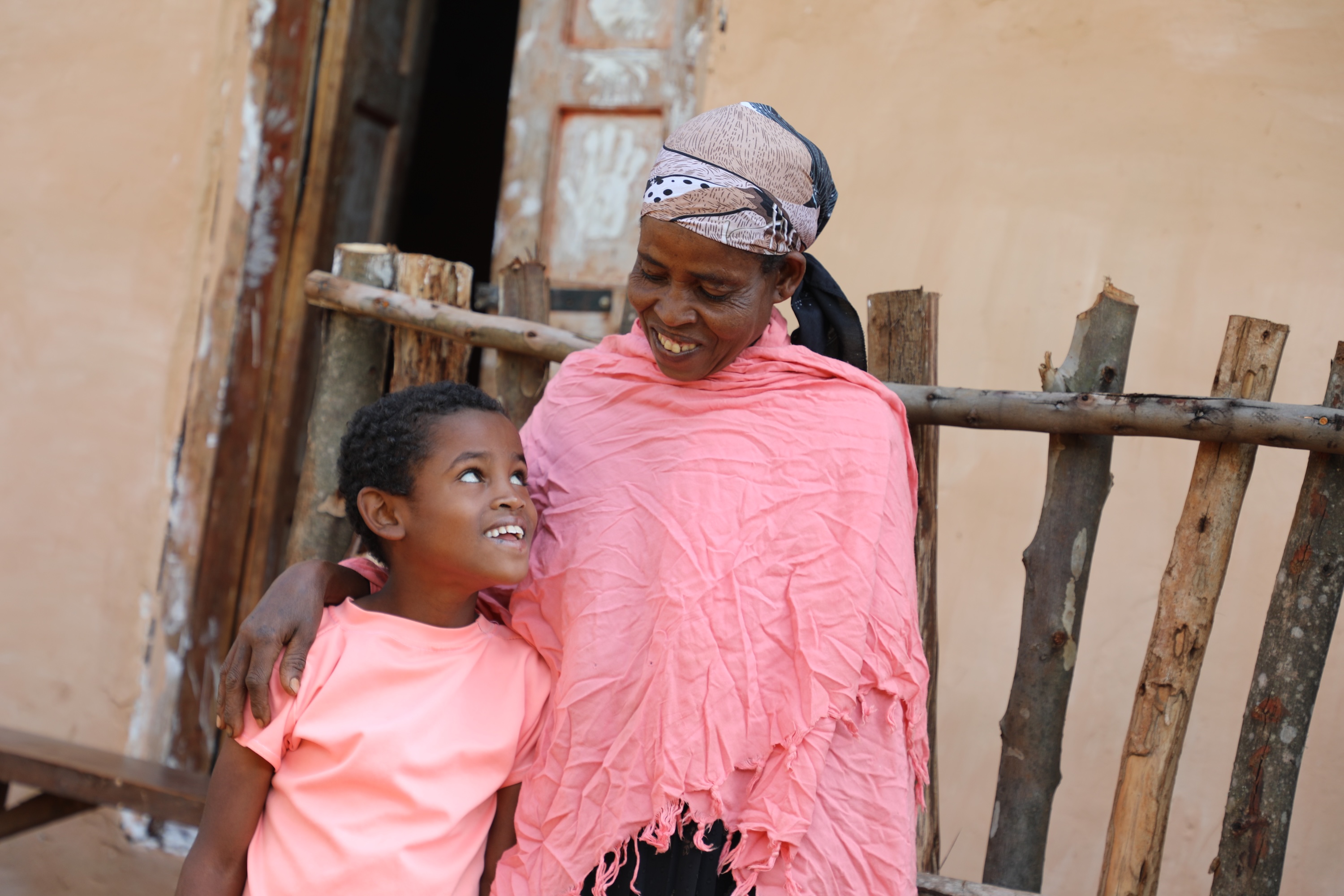 Abdi and his mom smiling at each other 