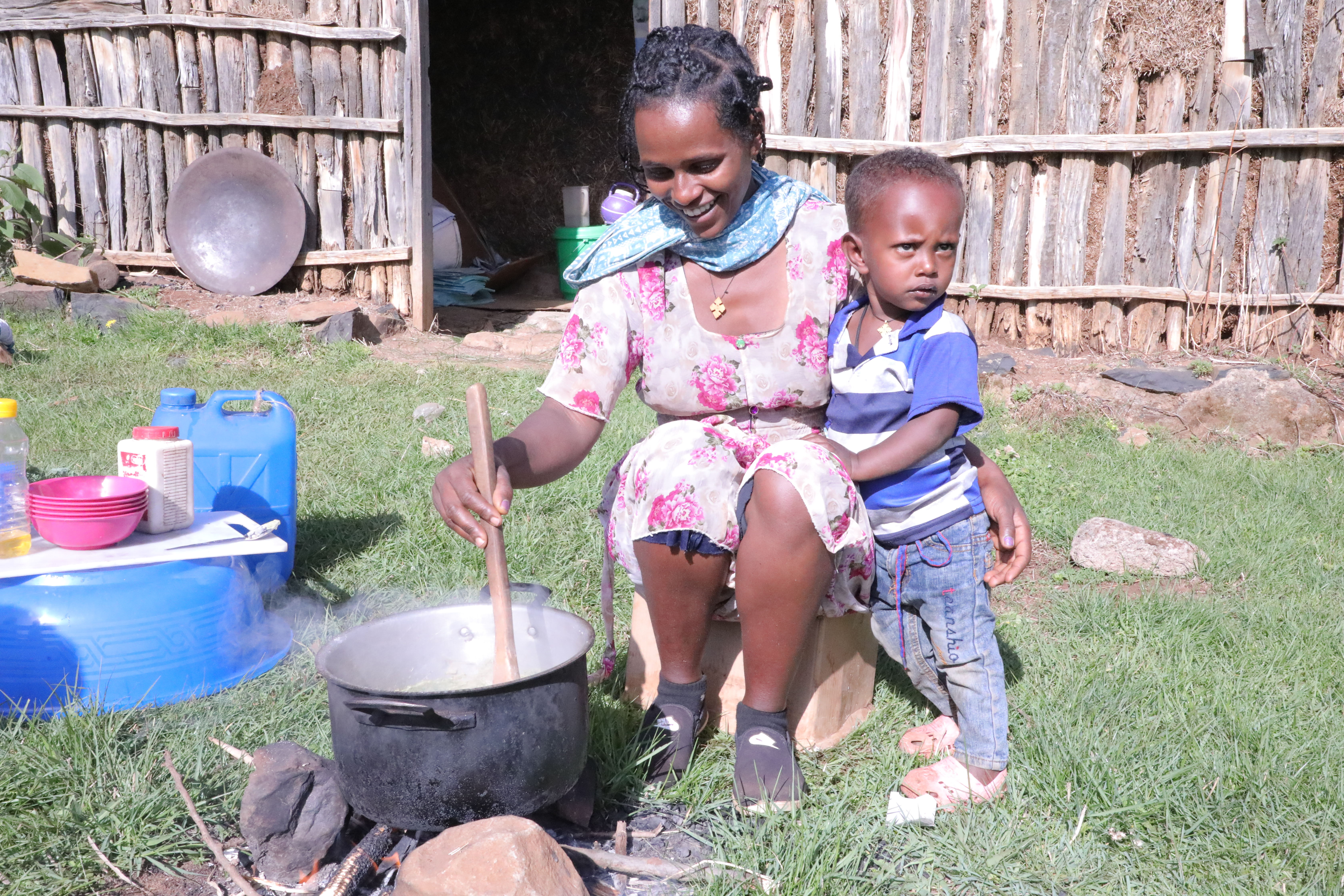 Emebet cooks a meal for her son as per the training she took