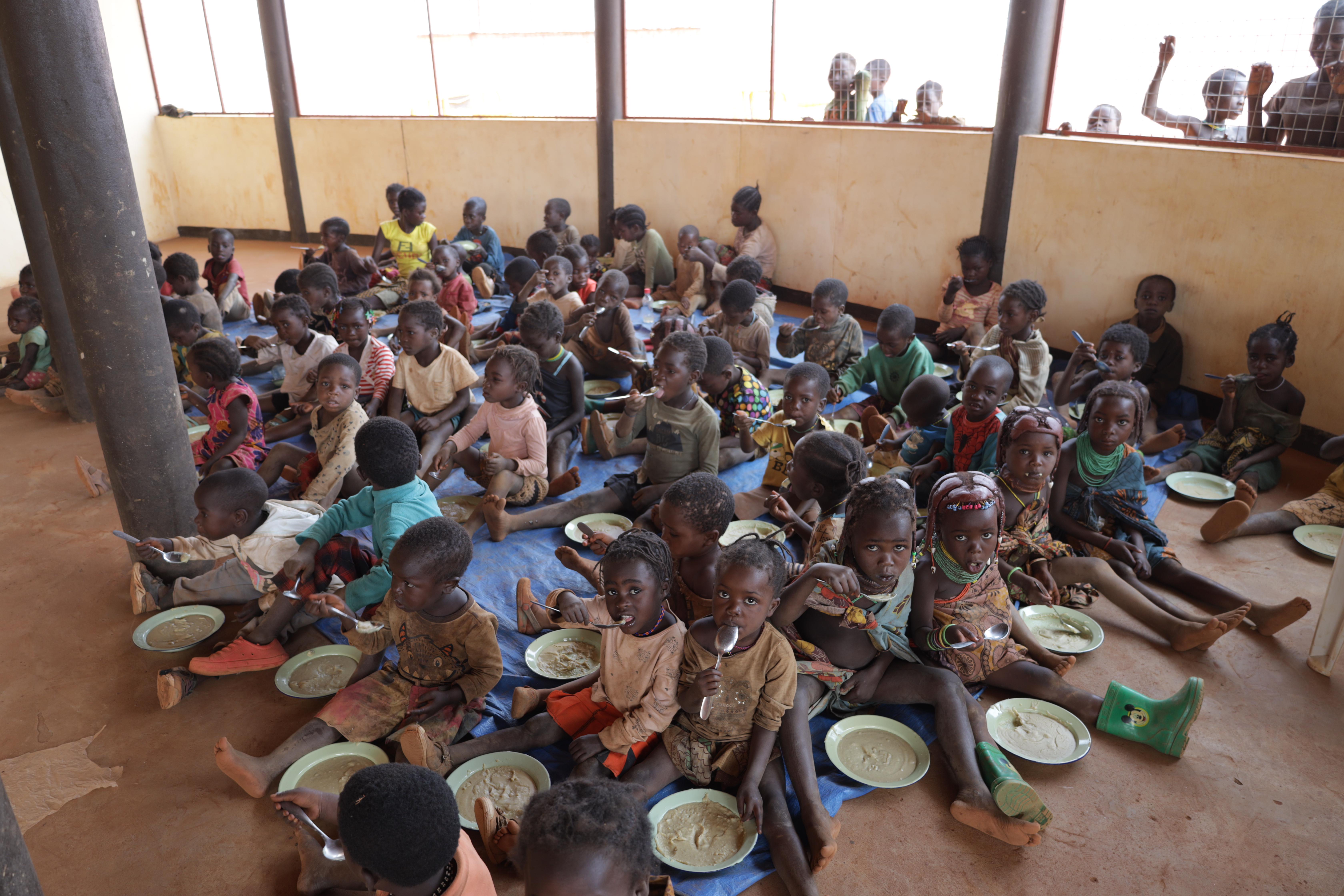 Children eating PREMIX porridge