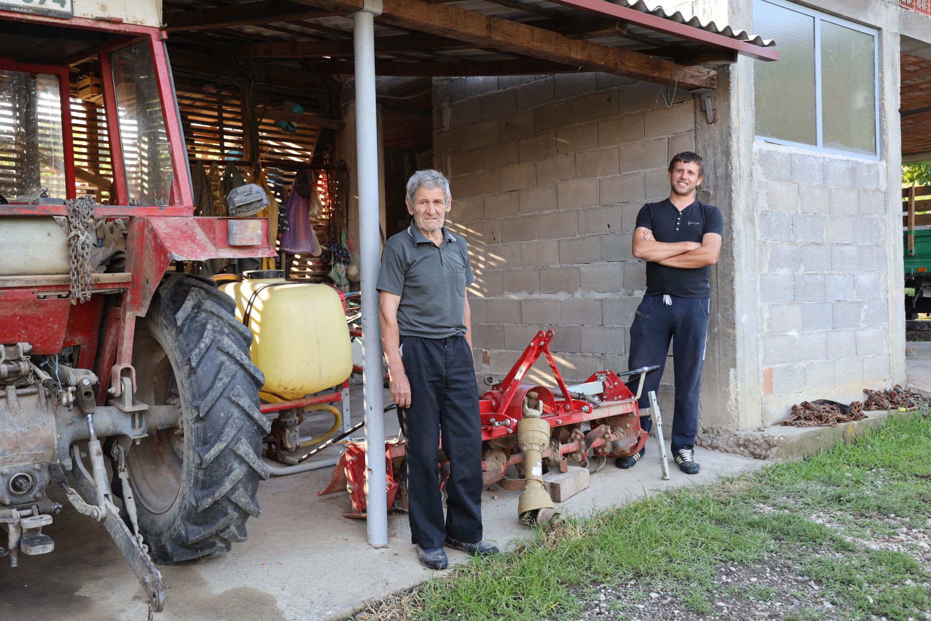 Ratko and his grandson Radislav stand by the donated tools