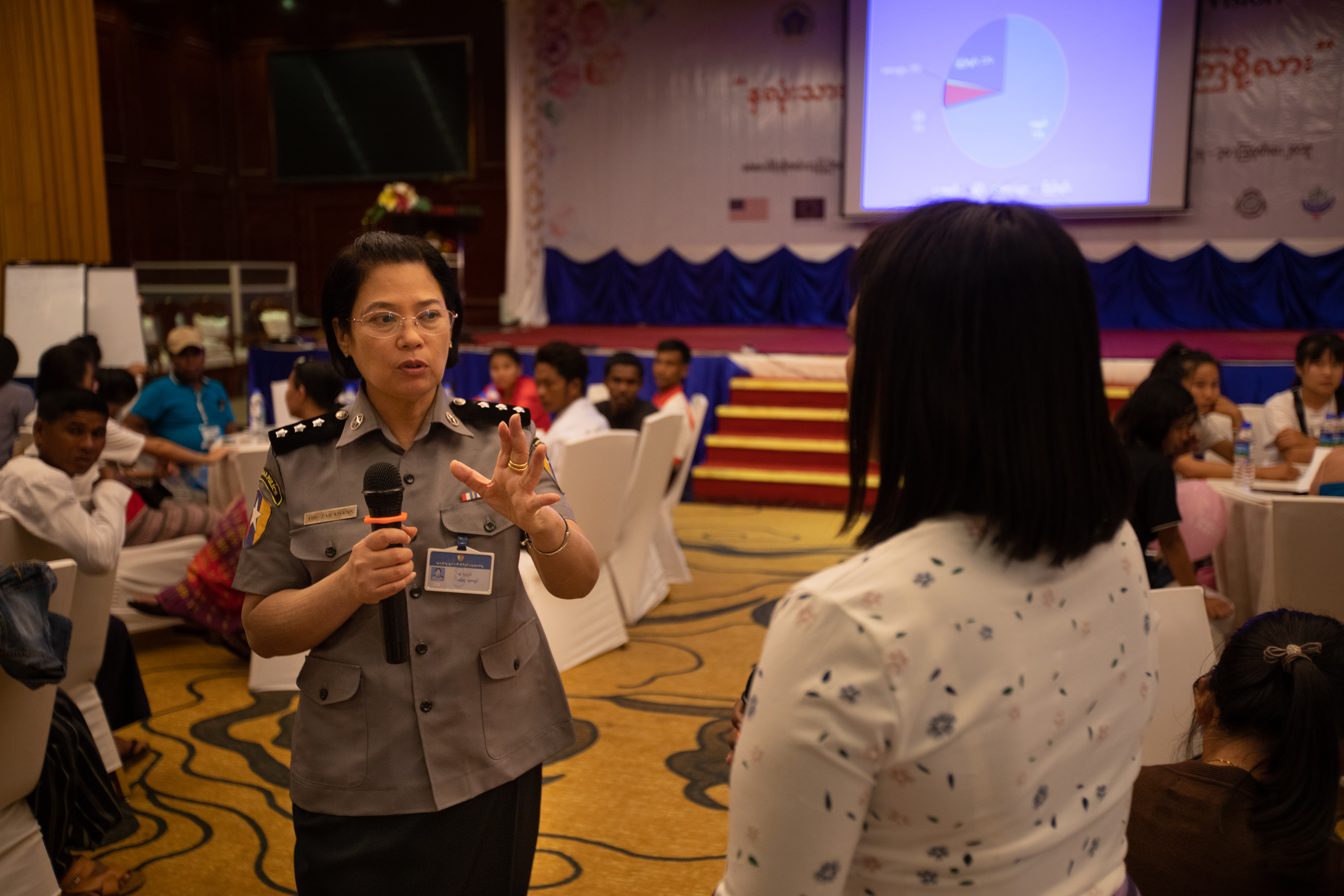 Trafficked returnees talks to an officer during discussion session 