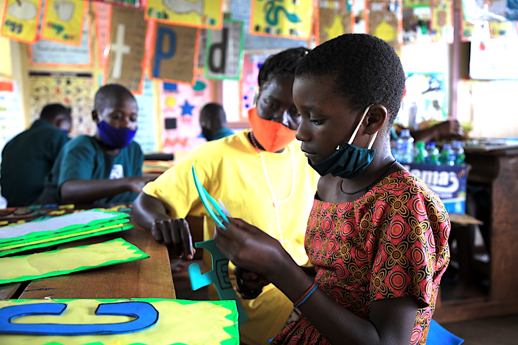 Maria in her print-rich classroom World Vision Uganda Education Improving classroom enviroment