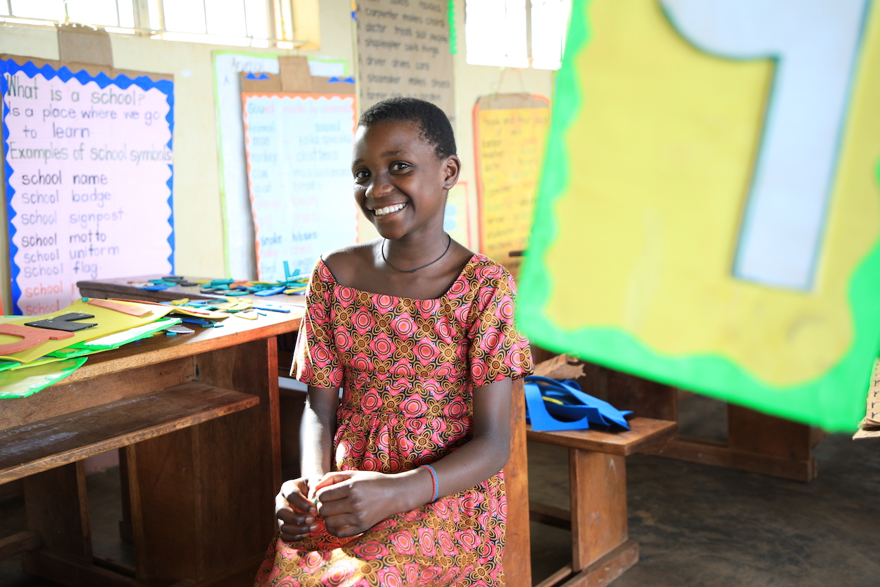 Maria in her print-rich classroom World Vision Uganda Education Improving classroom enviroment