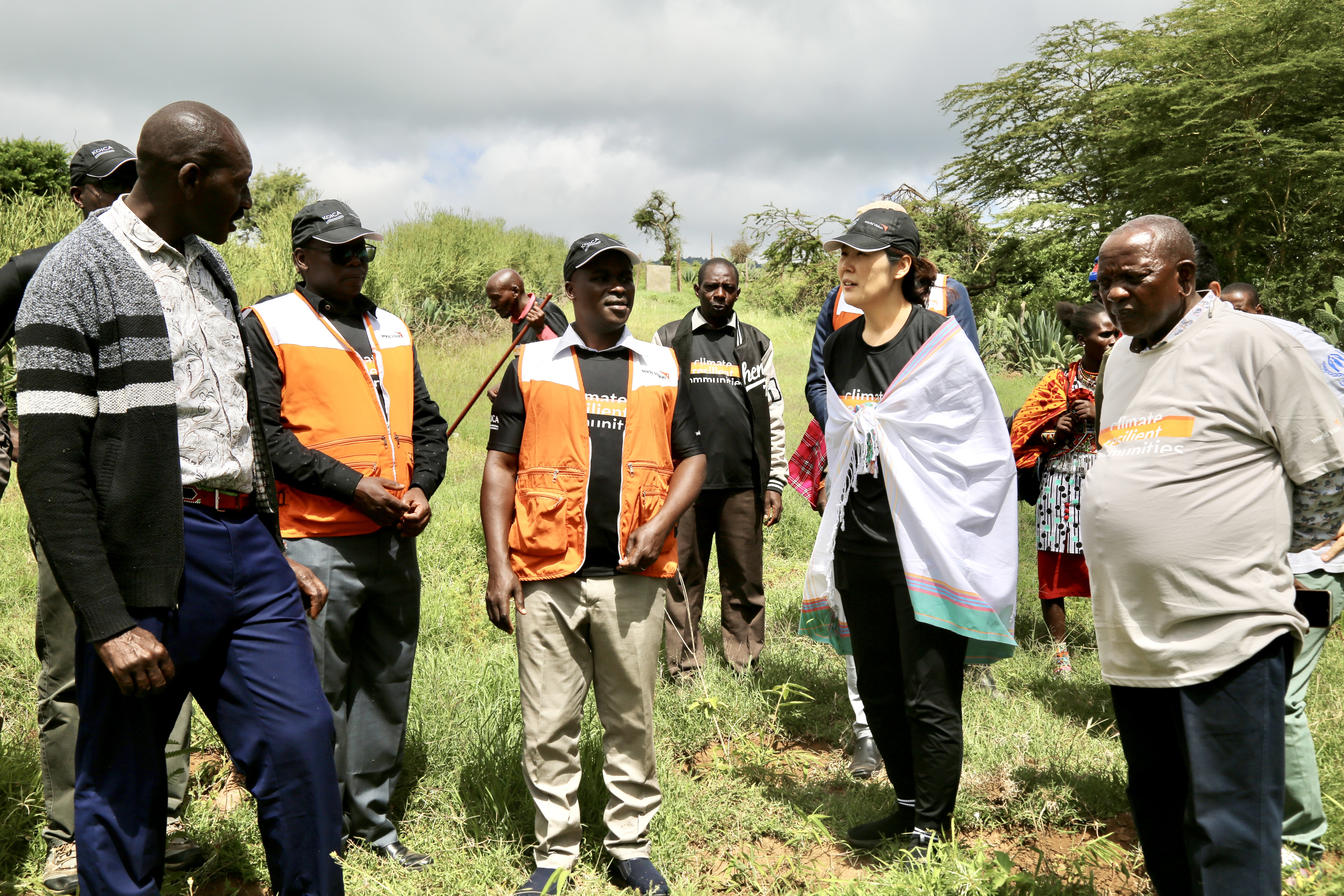 KOICA and World Vision team are briefed on water sources in Naroosura Ward that serves many families 