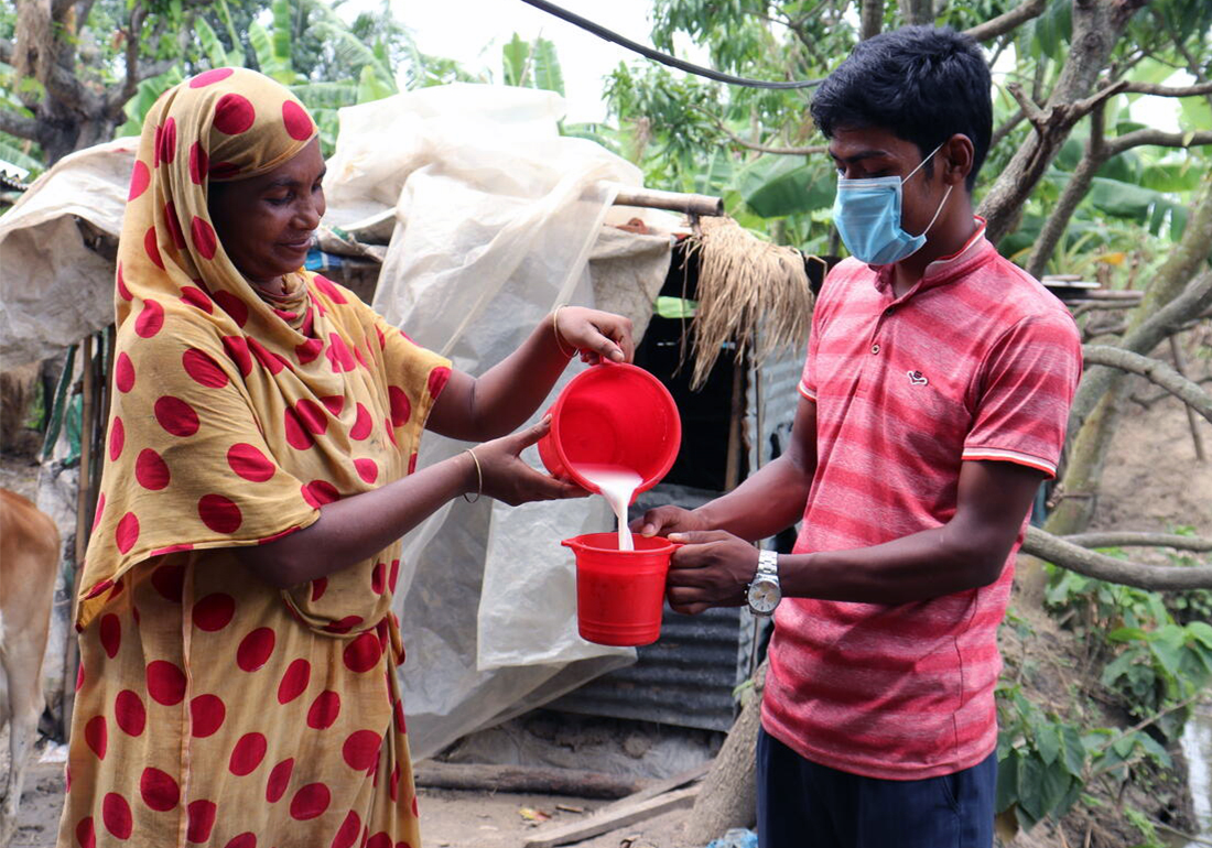 Khadija is selling milk from her cow to the vendor