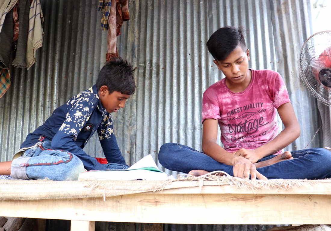 Abu and Hasan are helping each other in their study