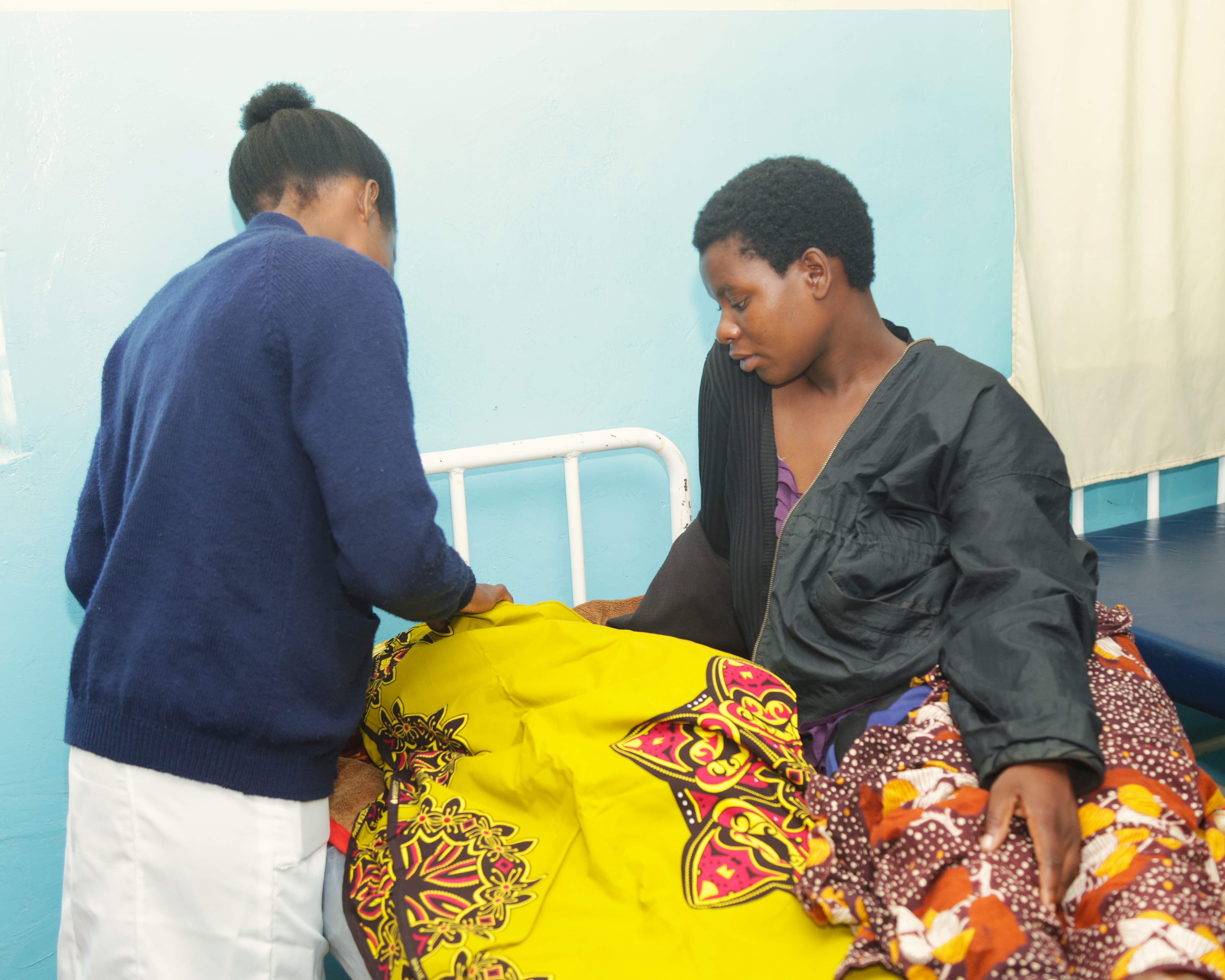 A nurse attending Margret and her baby at Chamba Health Center Maternity wing