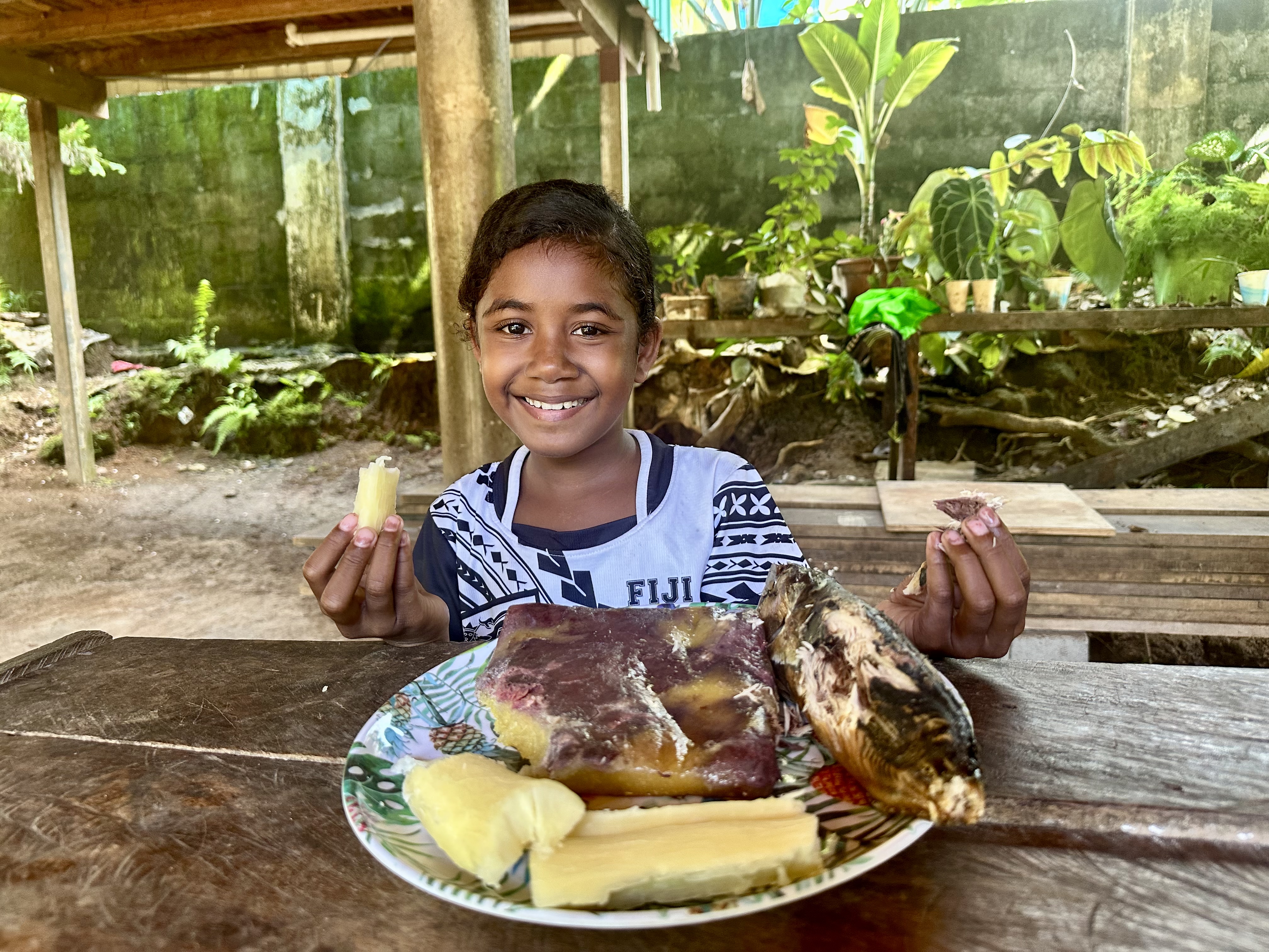 Xynah from the Feraladoa community enjoying traditional food/ Solomon Islands/ 2025.