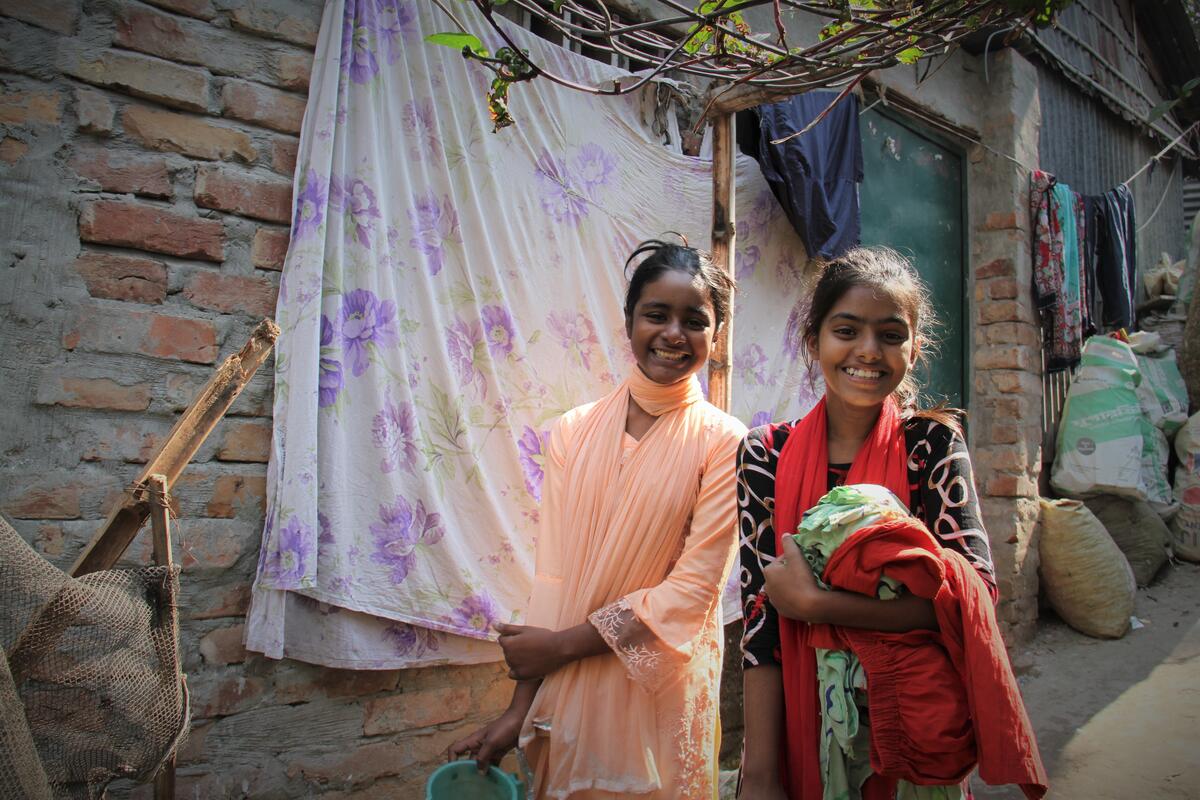 Mim walks confidently with her cousin to the hygiene facilities in Bangladesh