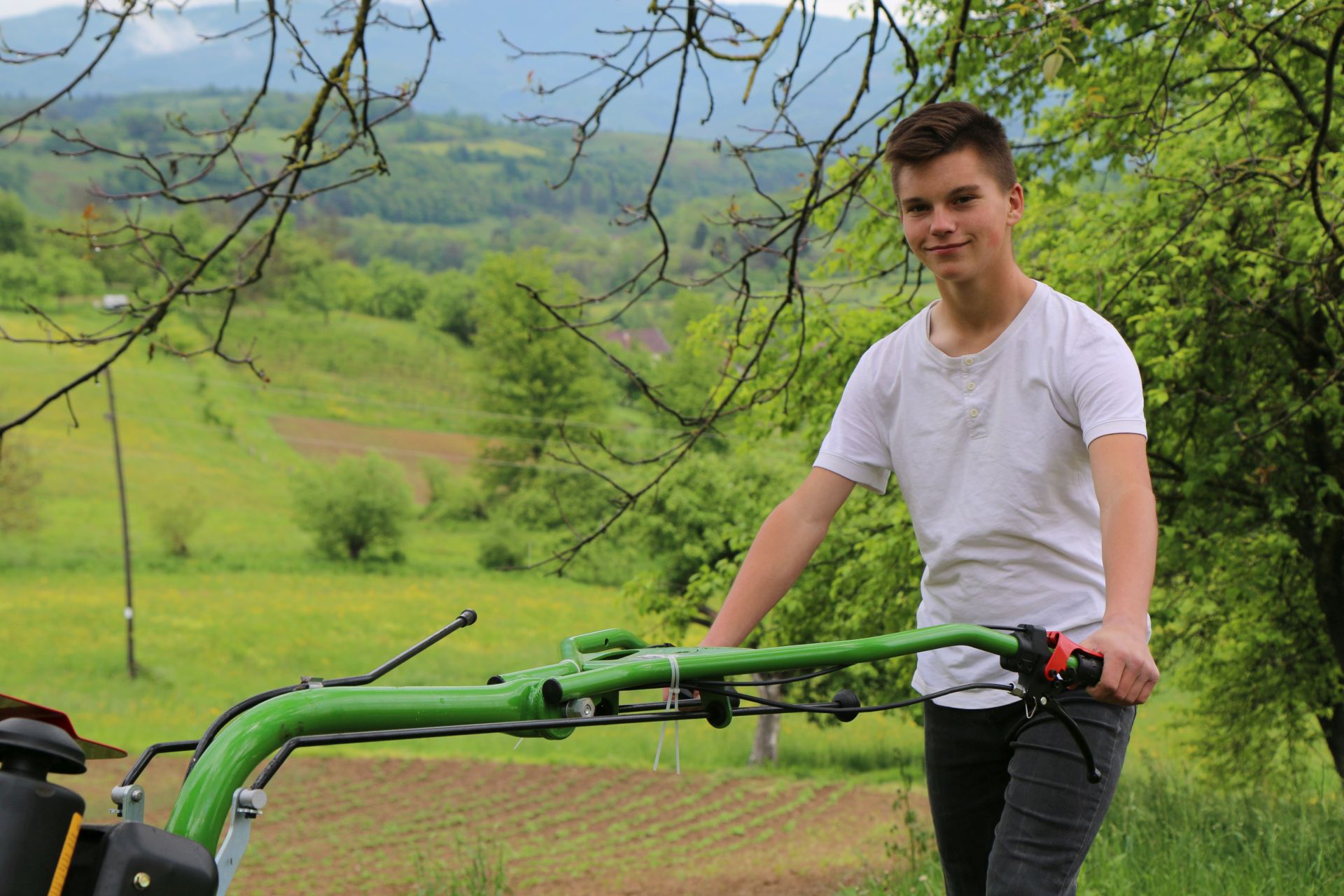 Amar pushes a donated tools up the hill